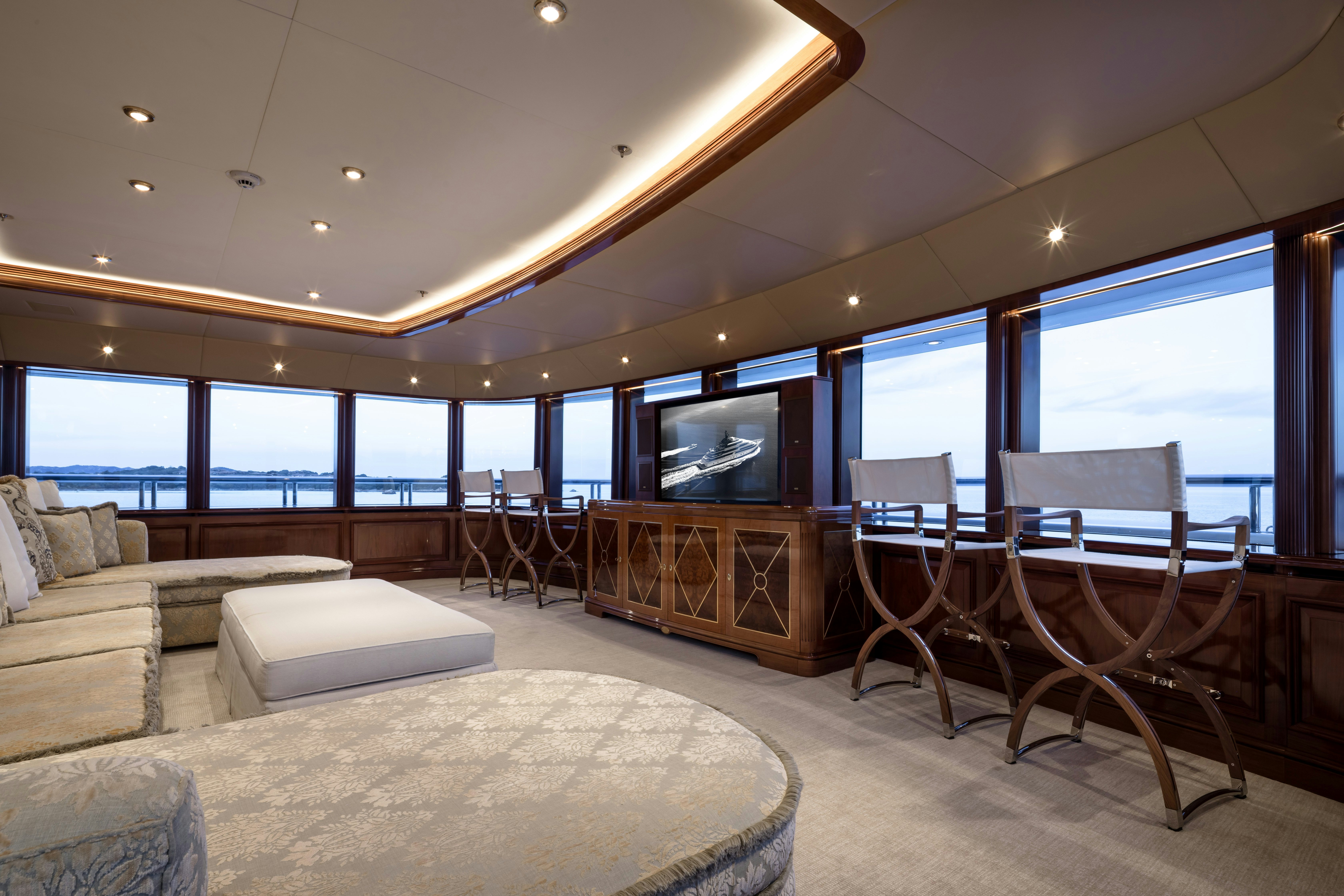 a living room with a large window aboard STARFIRE Yacht for Charter