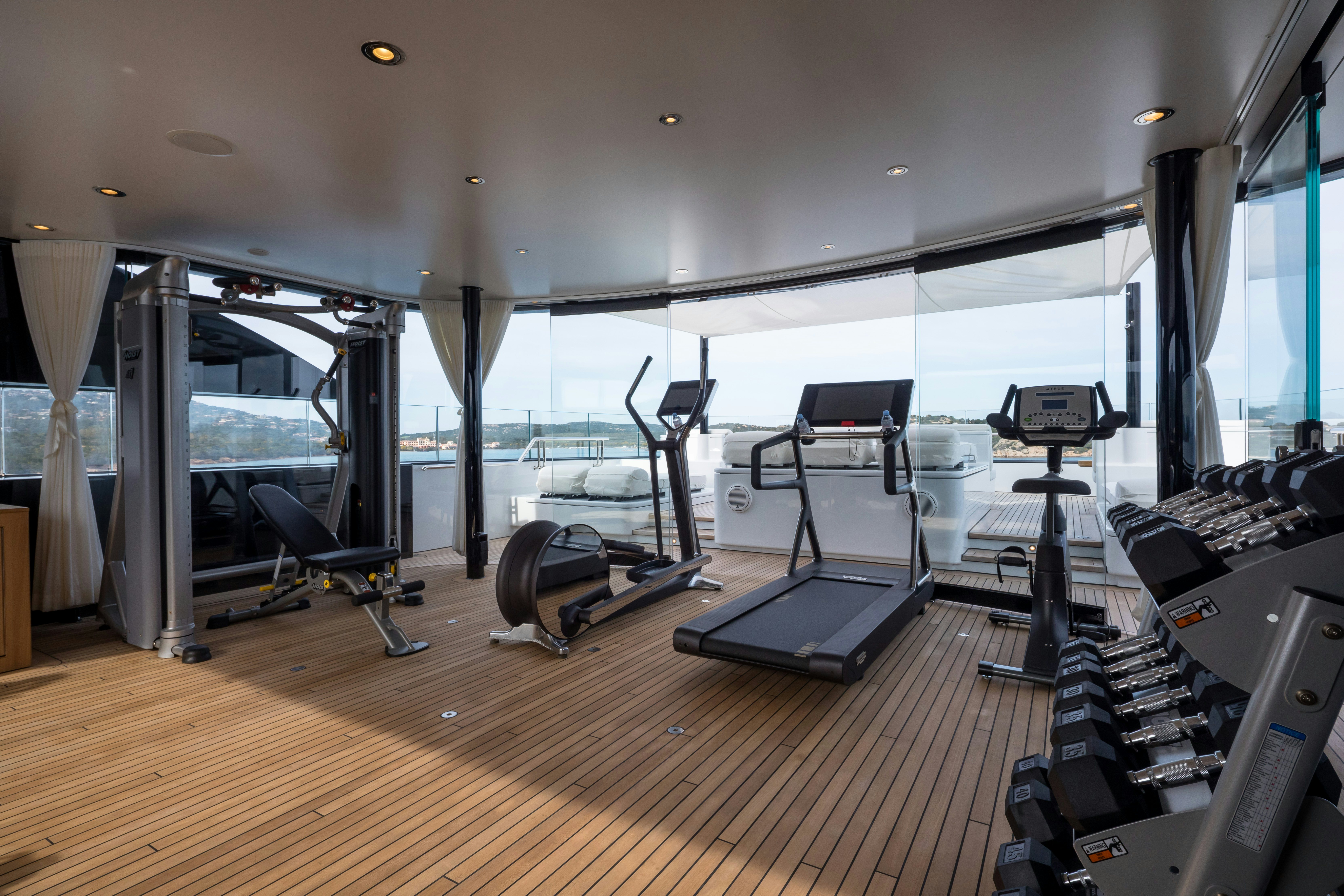 a gym with treadmills aboard STARFIRE Yacht for Charter