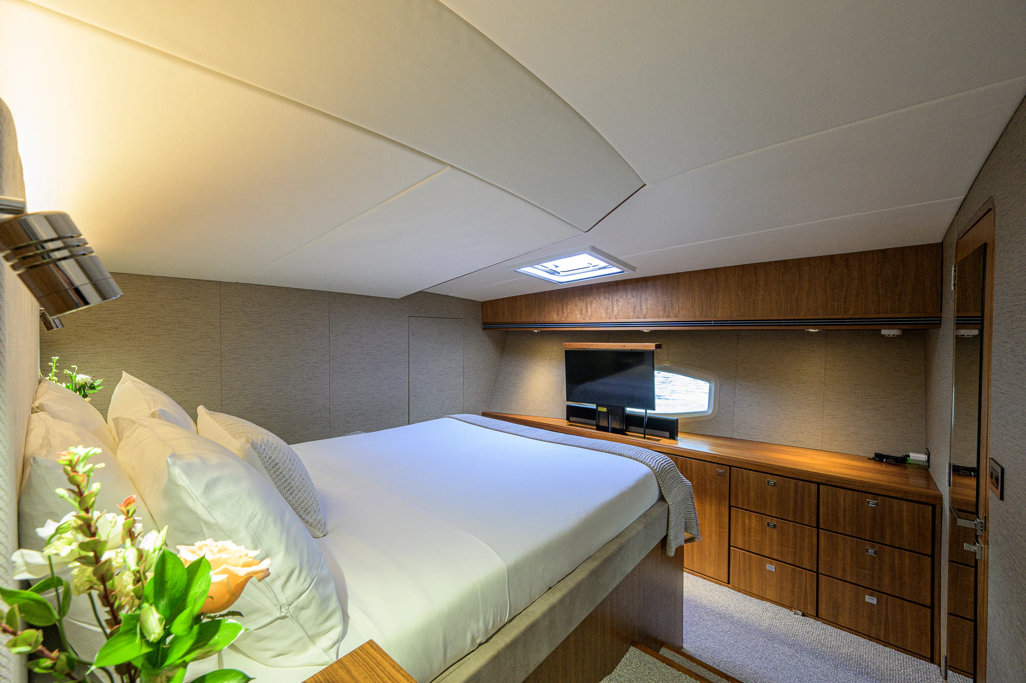 a bedroom with a bed and a television aboard TURQUOISE Yacht for Sale