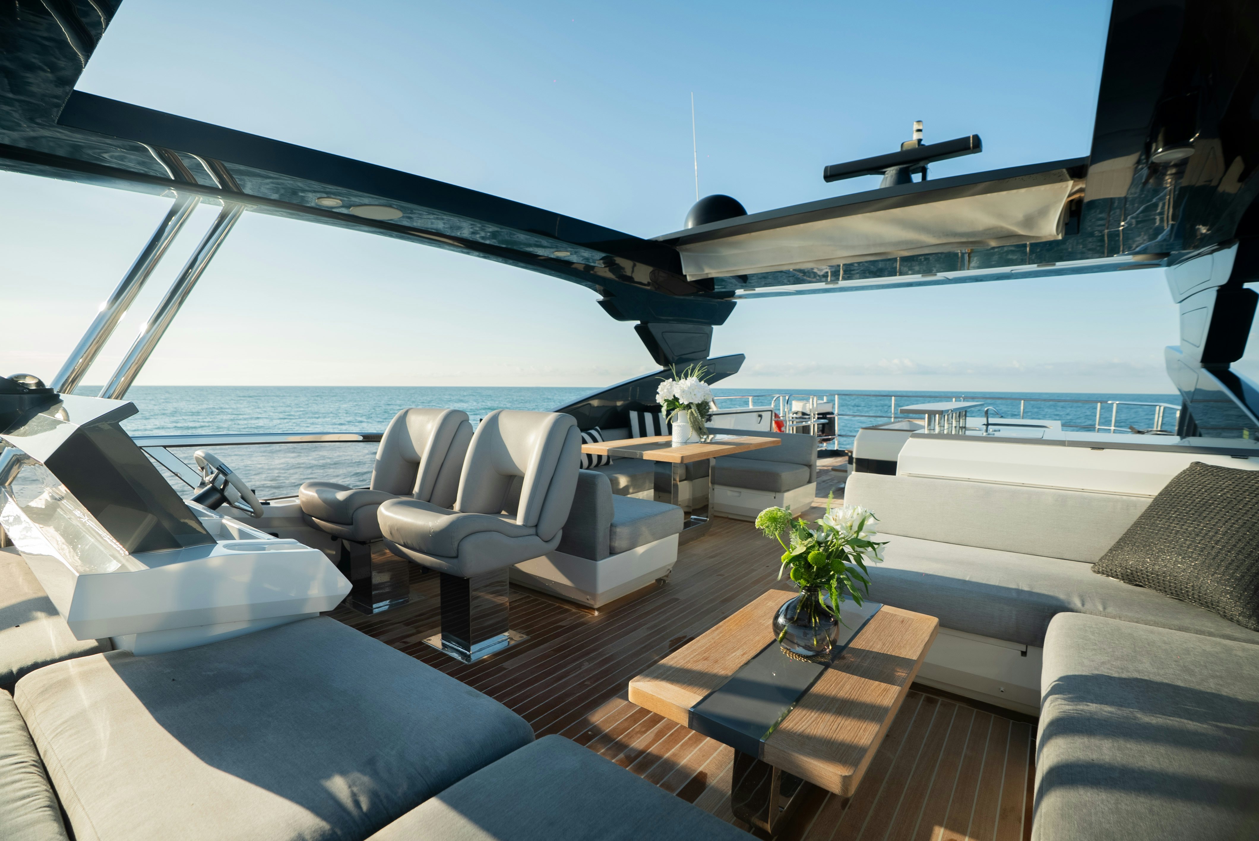 a large living room with a large balcony overlooking the ocean aboard OMNIA Yacht for Sale