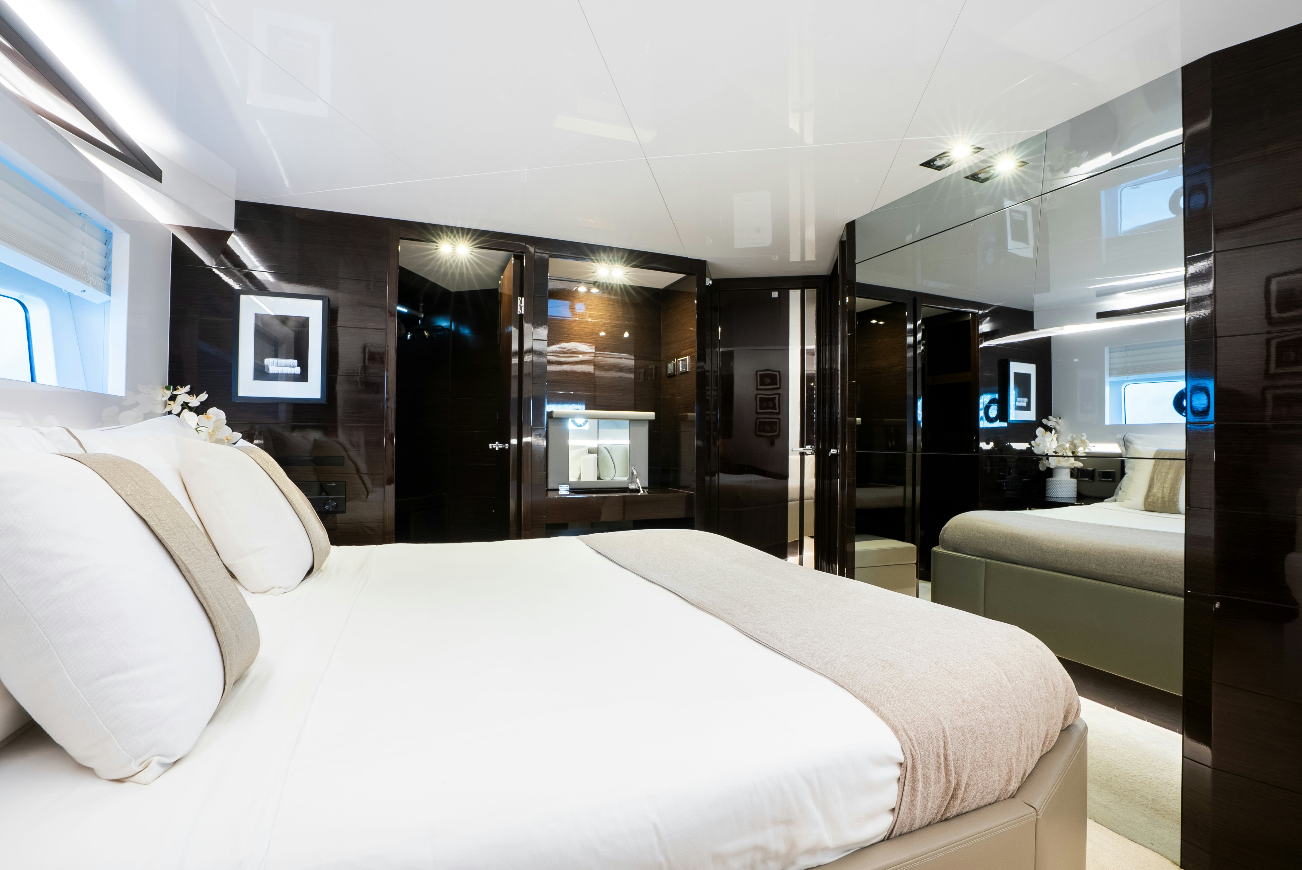a room with a bed and a large mirror aboard OMNIA Yacht for Sale