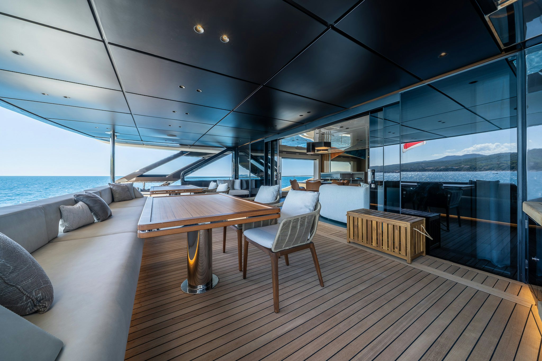 a room with a wood table and chairs and a large window aboard ACALI Yacht for Sale