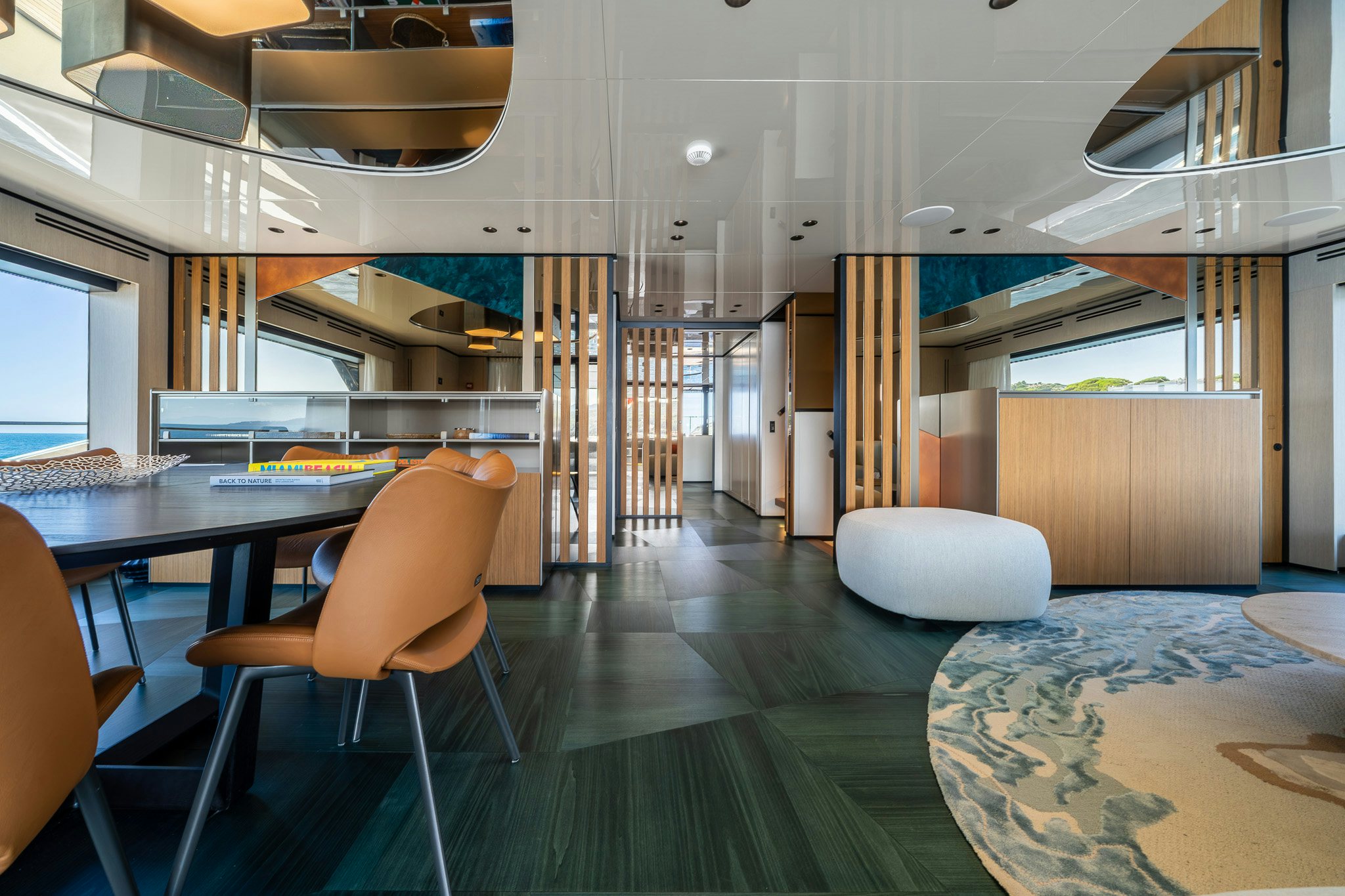 a room with tables and chairs aboard ACALI Yacht for Sale