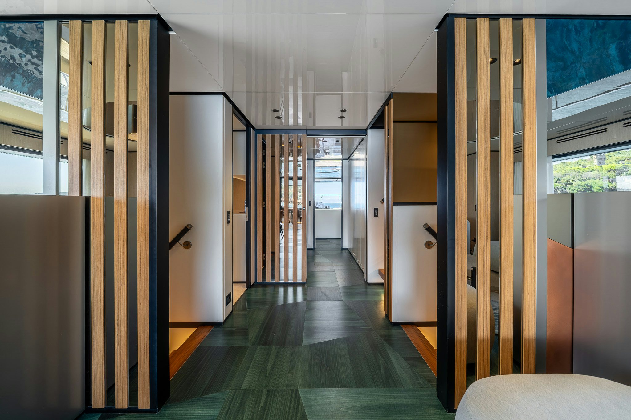 a wood deck with glass doors aboard ACALI Yacht for Sale