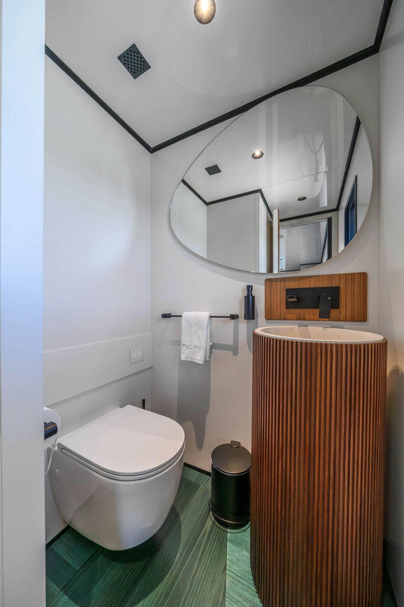 a bathroom with a toilet and a mirror aboard ACALI Yacht for Sale