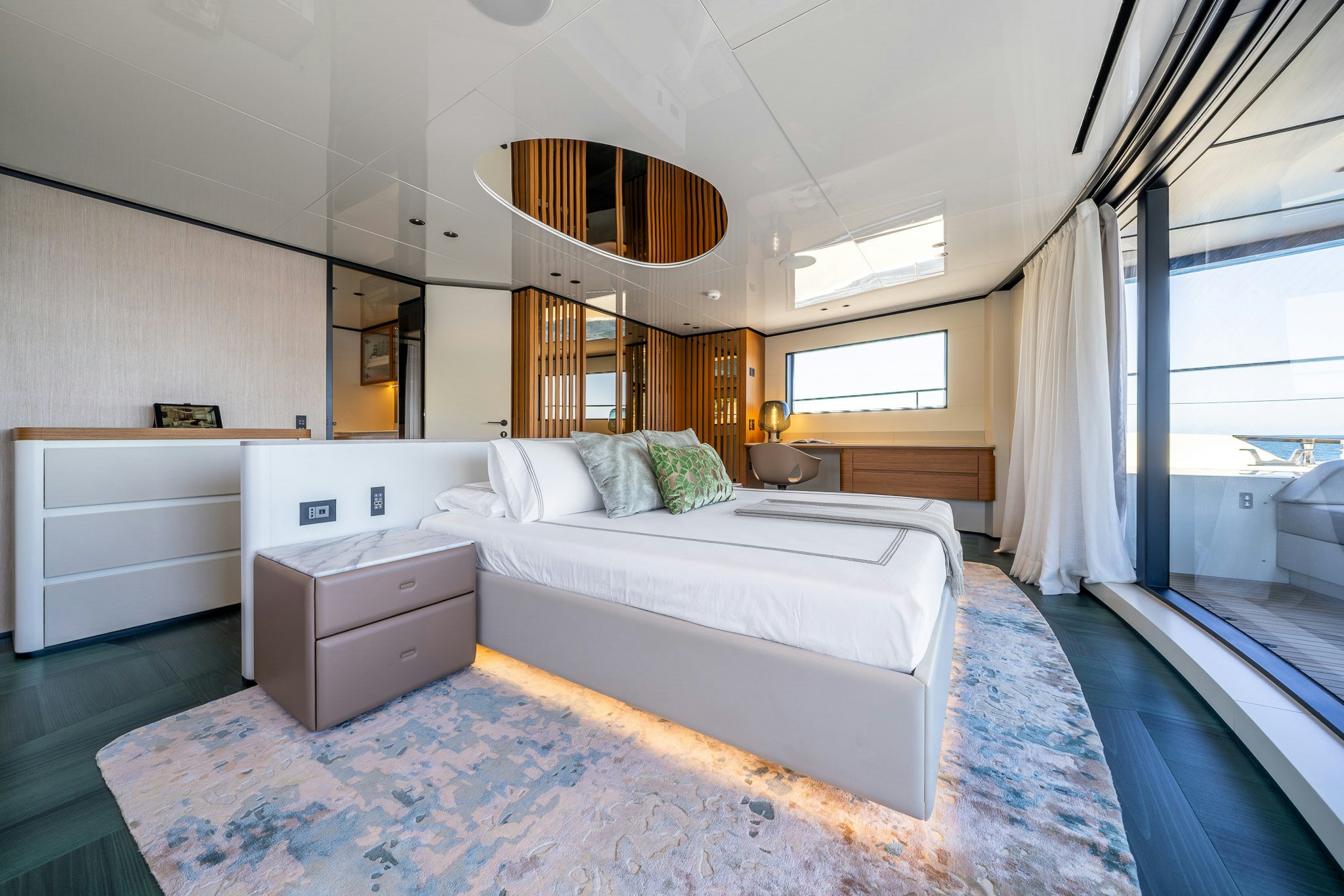 a bedroom with a bed and a window aboard ACALI Yacht for Sale