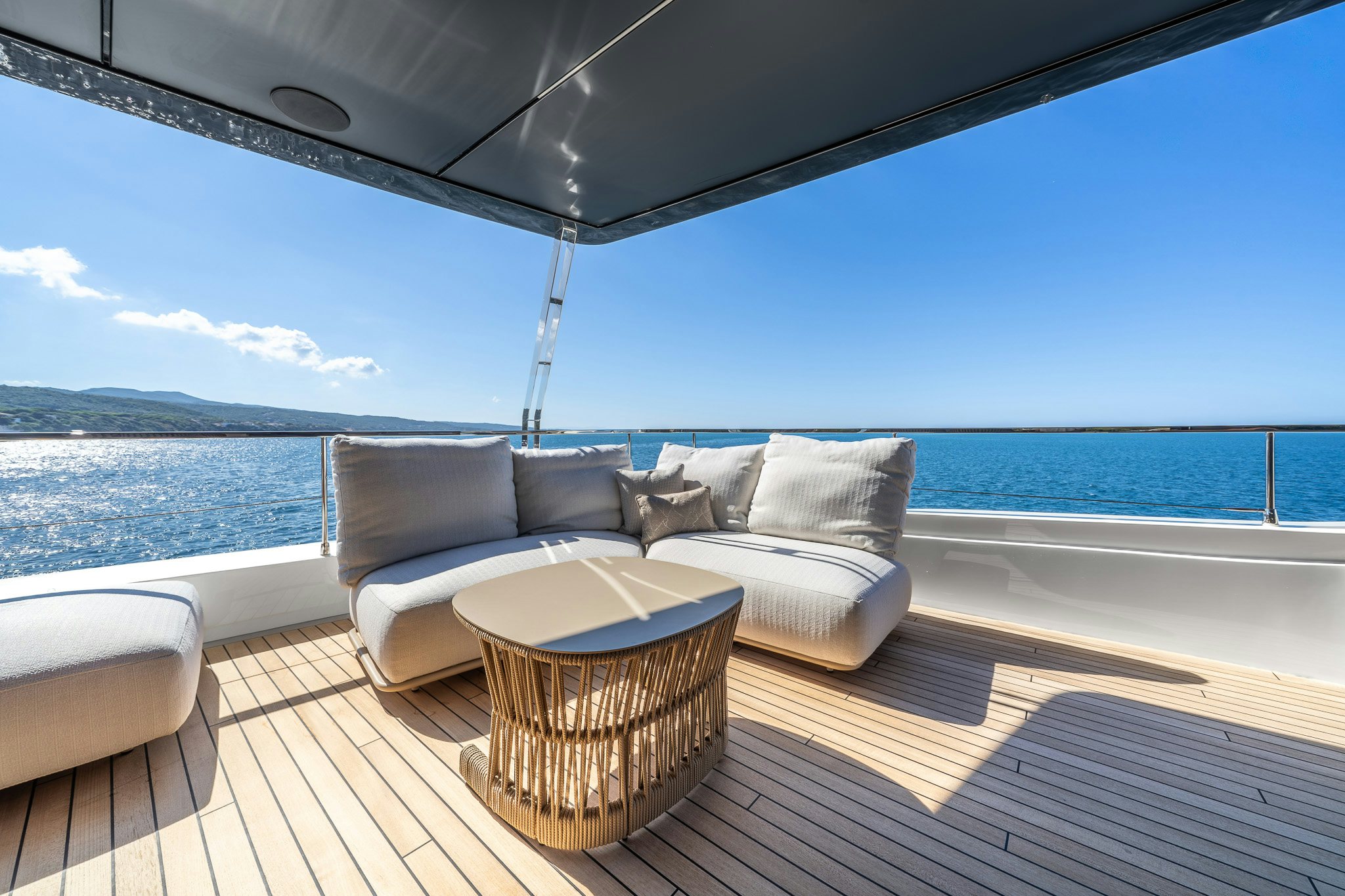 a couch on a deck overlooking a body of water aboard ACALI Yacht for Sale