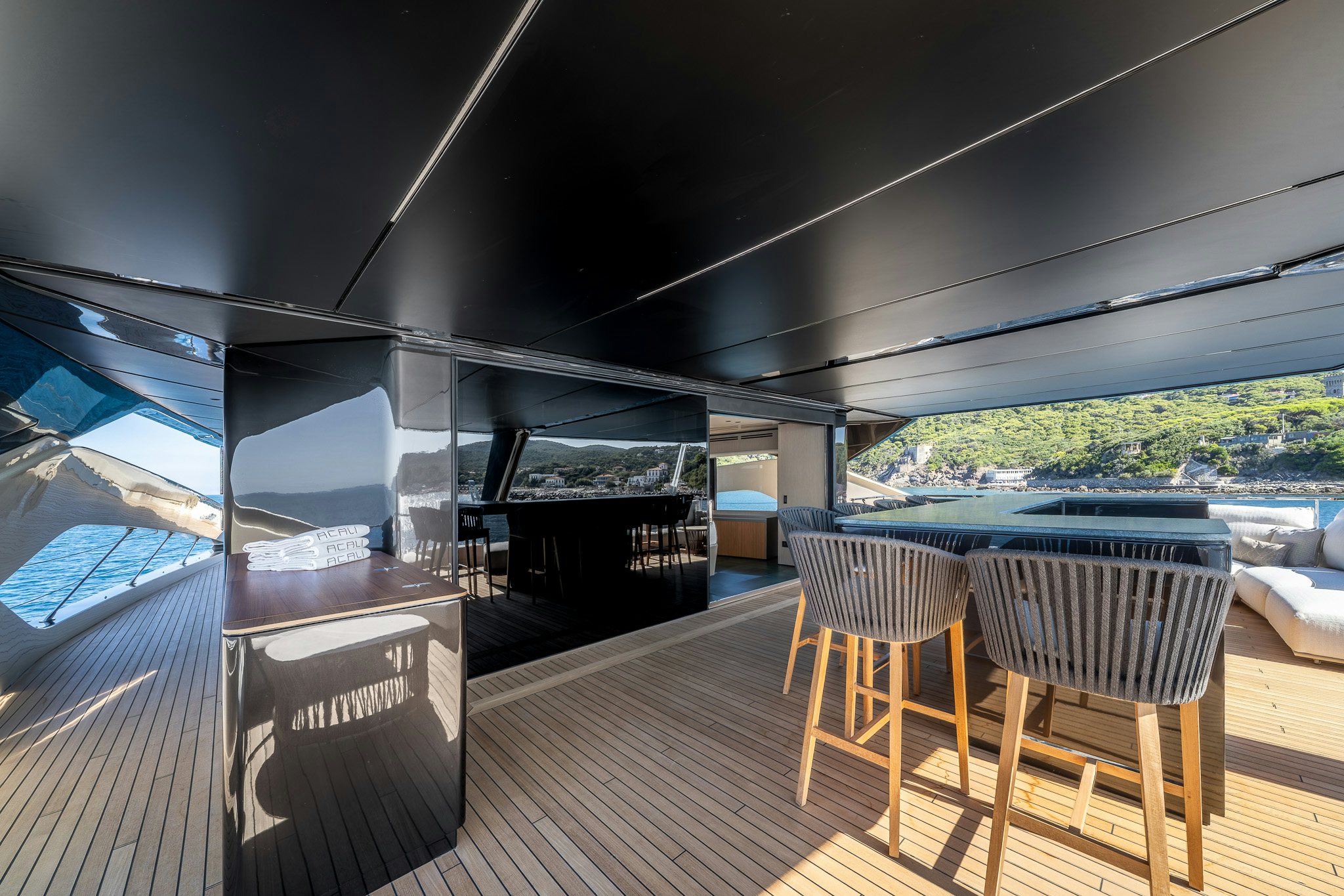 a deck with a view of the water and the land aboard ACALI Yacht for Sale