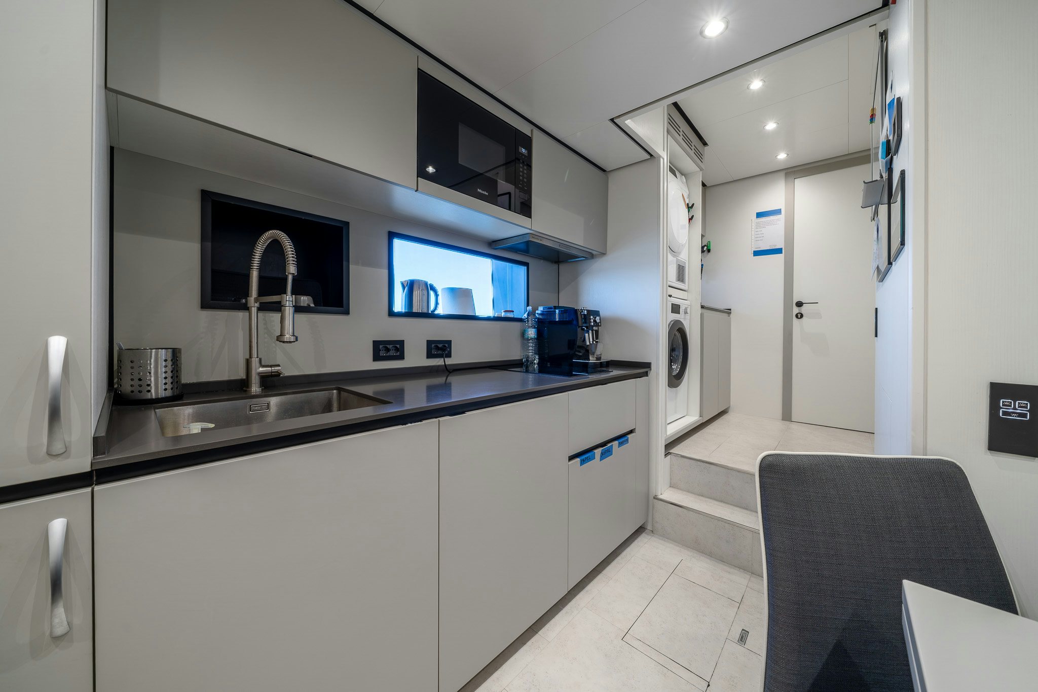 a kitchen with a sink and a tv aboard ACALI Yacht for Sale