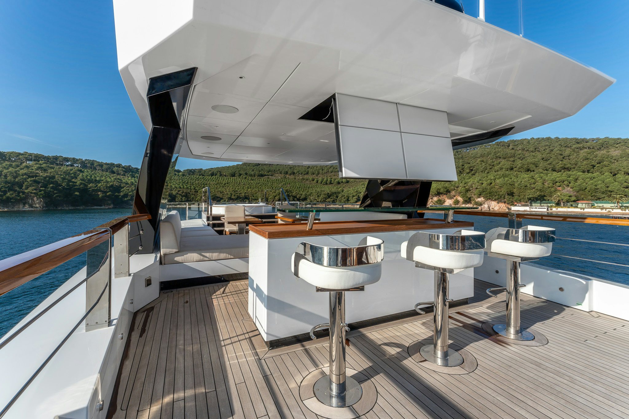 a deck with a table and chairs on it aboard MERELEY I Yacht for Sale