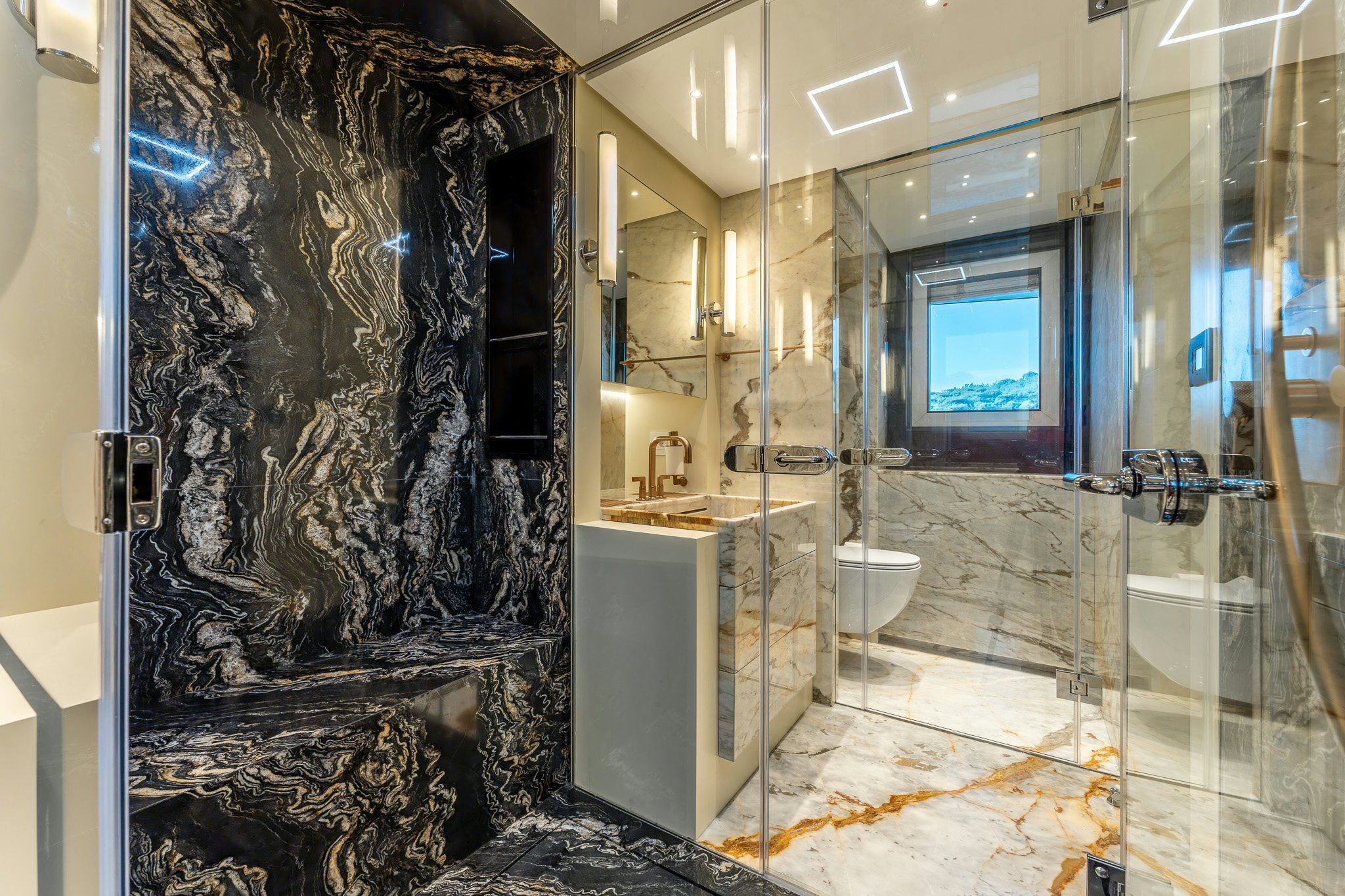 a bathroom with a glass shower aboard MERELEY I Yacht for Sale