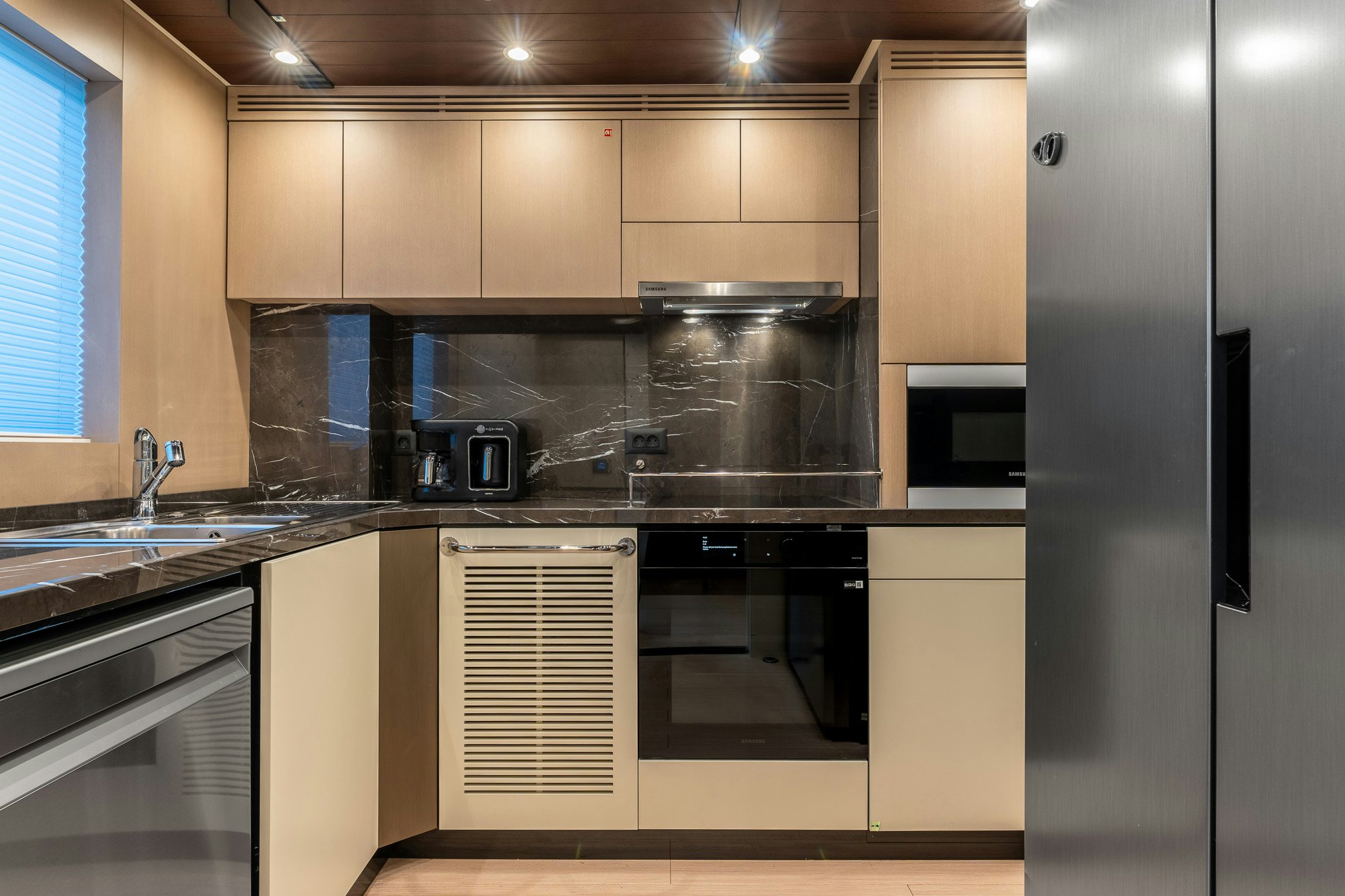 a kitchen with stainless steel appliances aboard MERELEY I Yacht for Sale