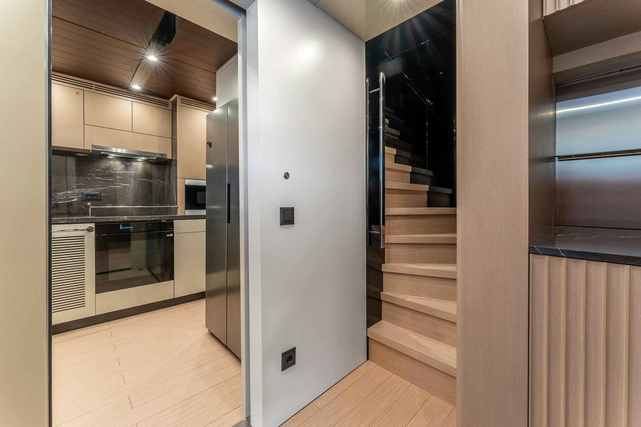 a kitchen with a large refrigerator aboard MERELEY I Yacht for Sale