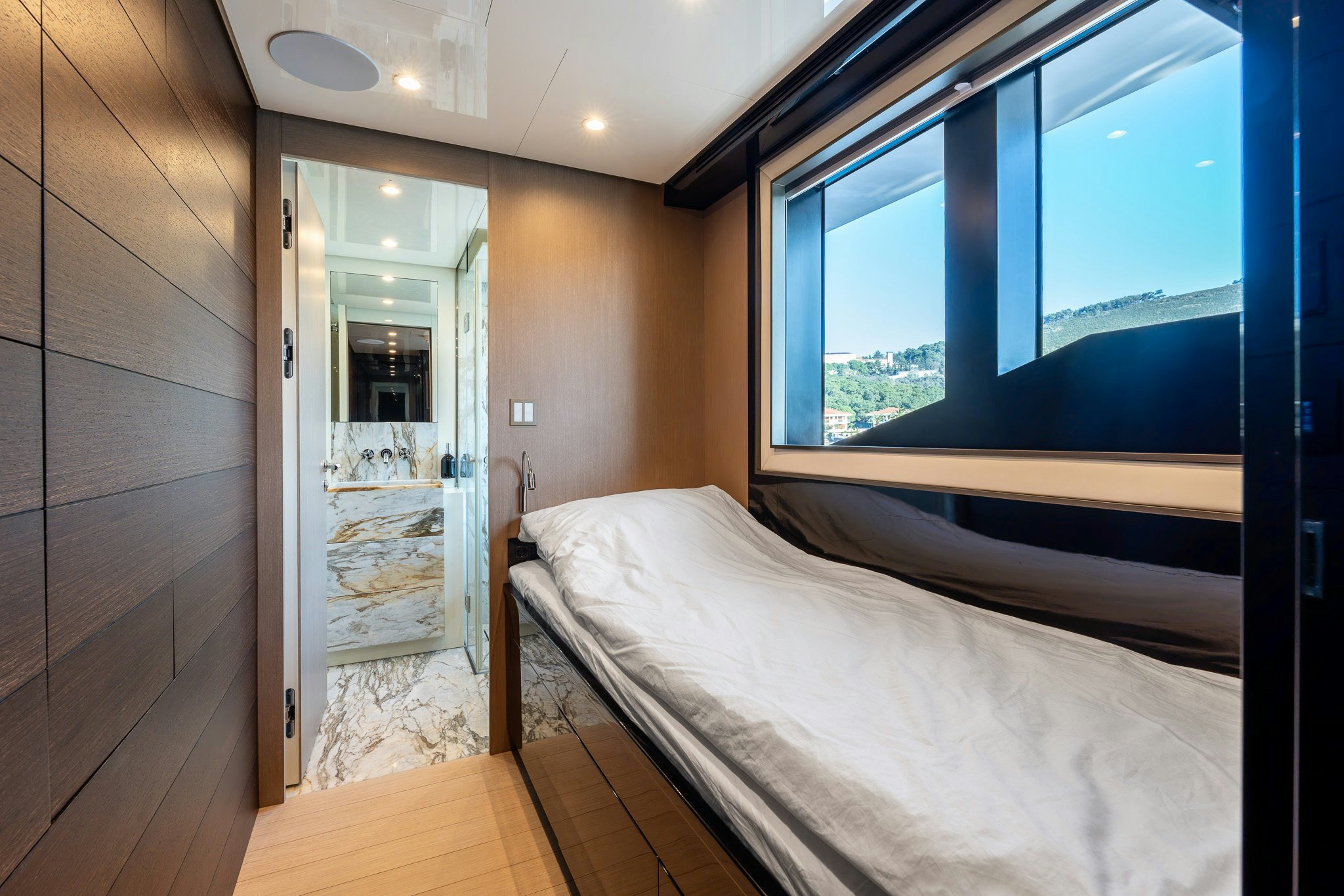 a bedroom with a large window aboard MERELEY I Yacht for Sale