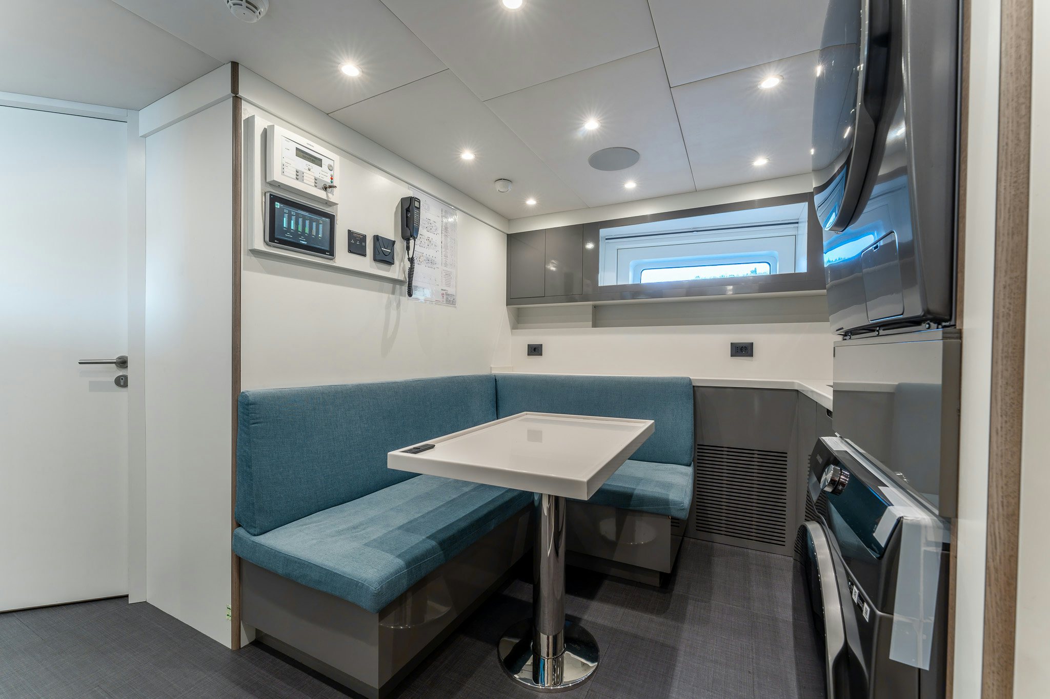 a room with a table and a couch aboard MERELEY I Yacht for Sale