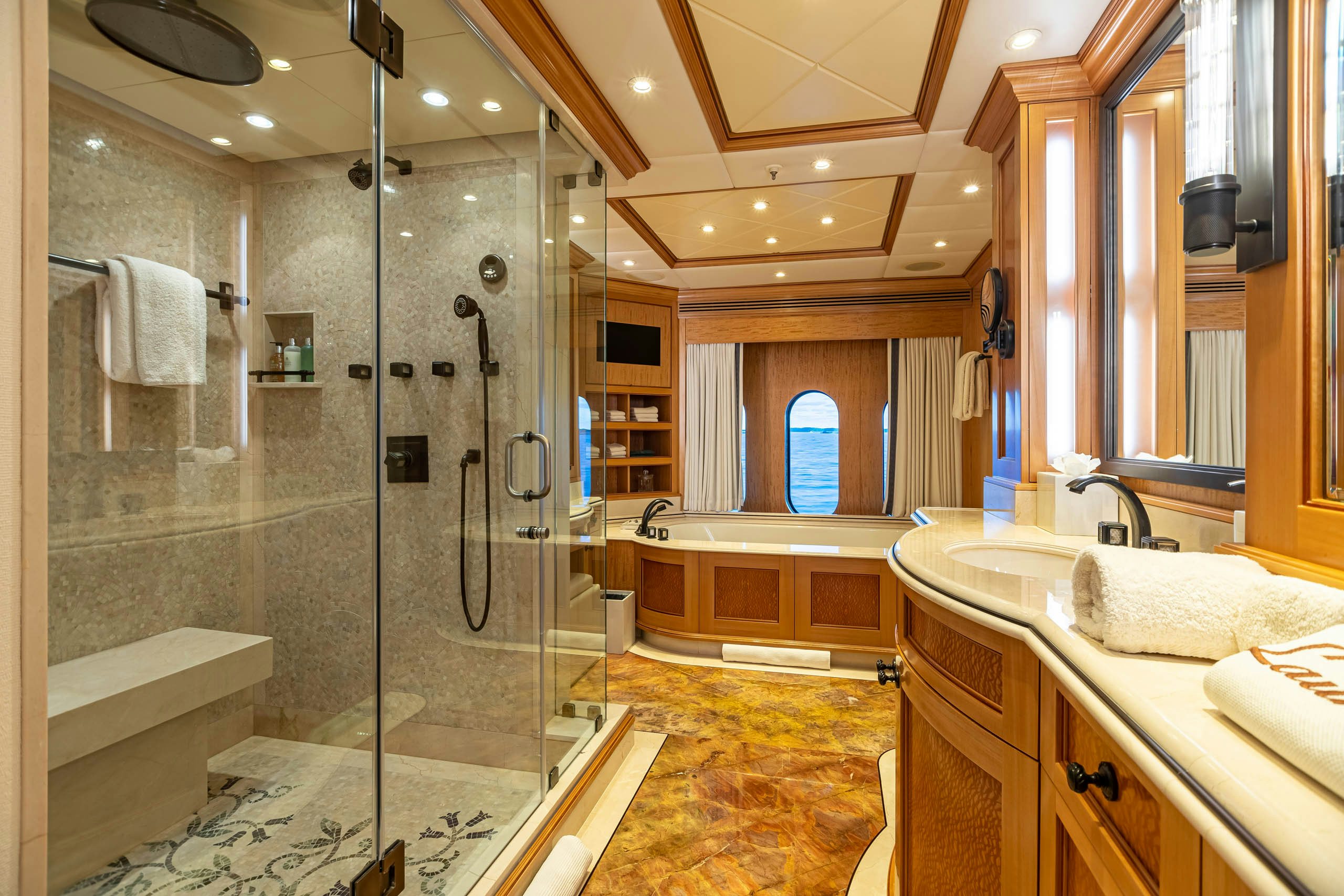 a bathroom with a glass shower aboard UNBRIDLED Yacht for Charter