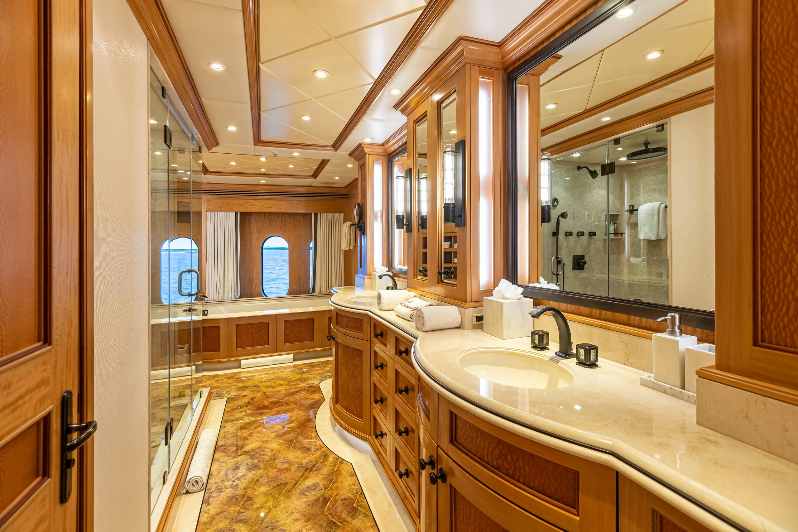 a bathroom with a large mirror aboard UNBRIDLED Yacht for Charter