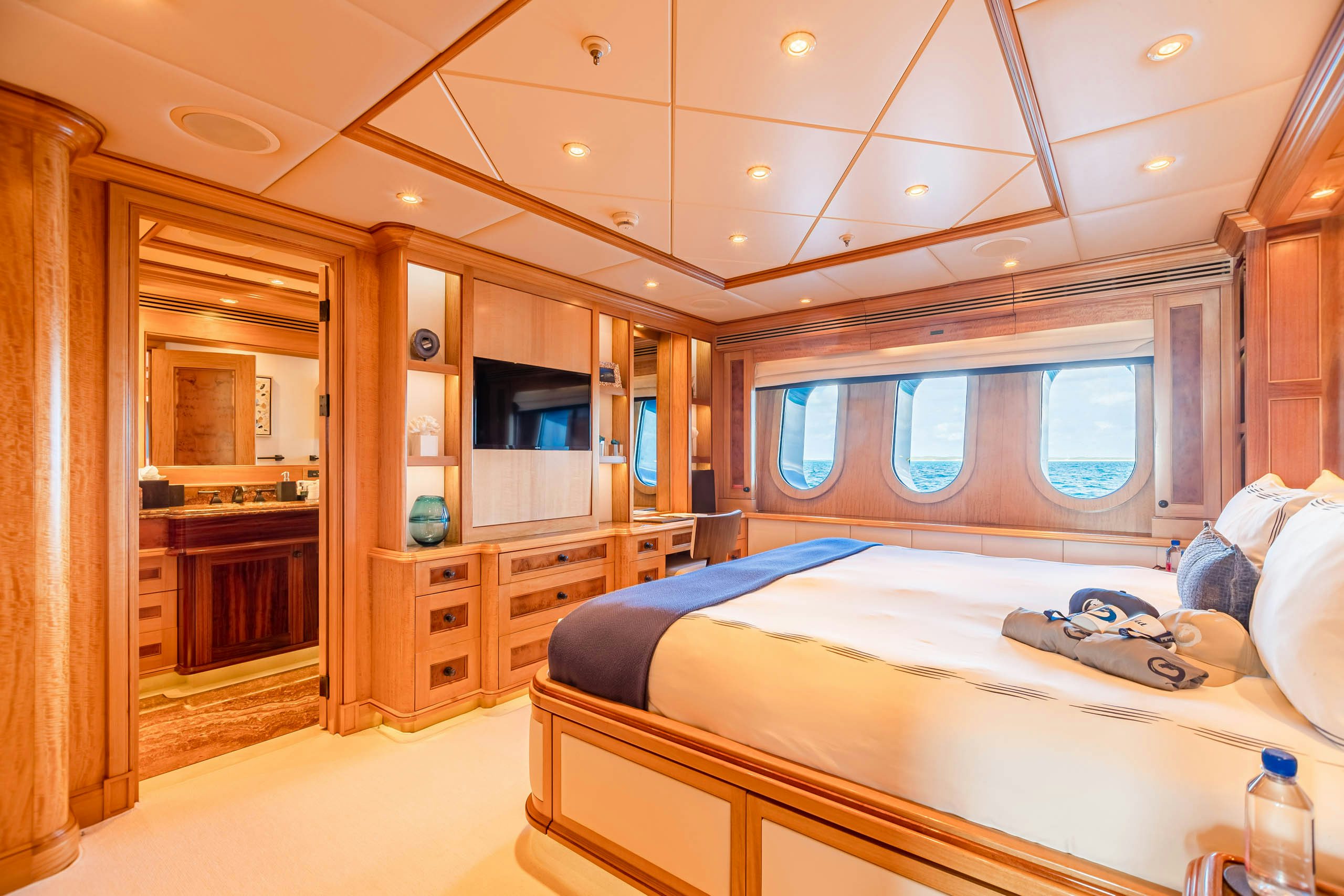 a bedroom with a bed and a closet aboard UNBRIDLED Yacht for Charter