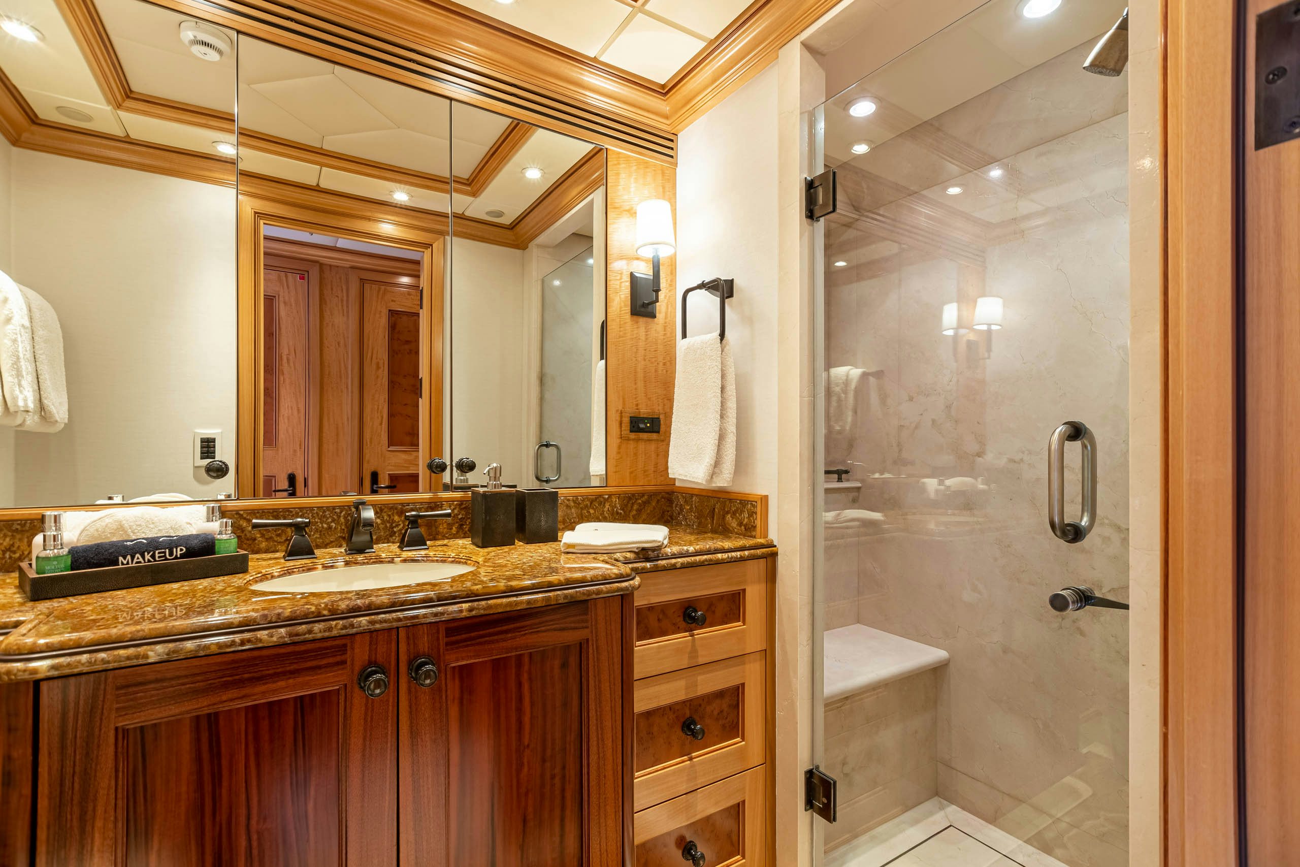 a bathroom with a glass shower aboard UNBRIDLED Yacht for Charter