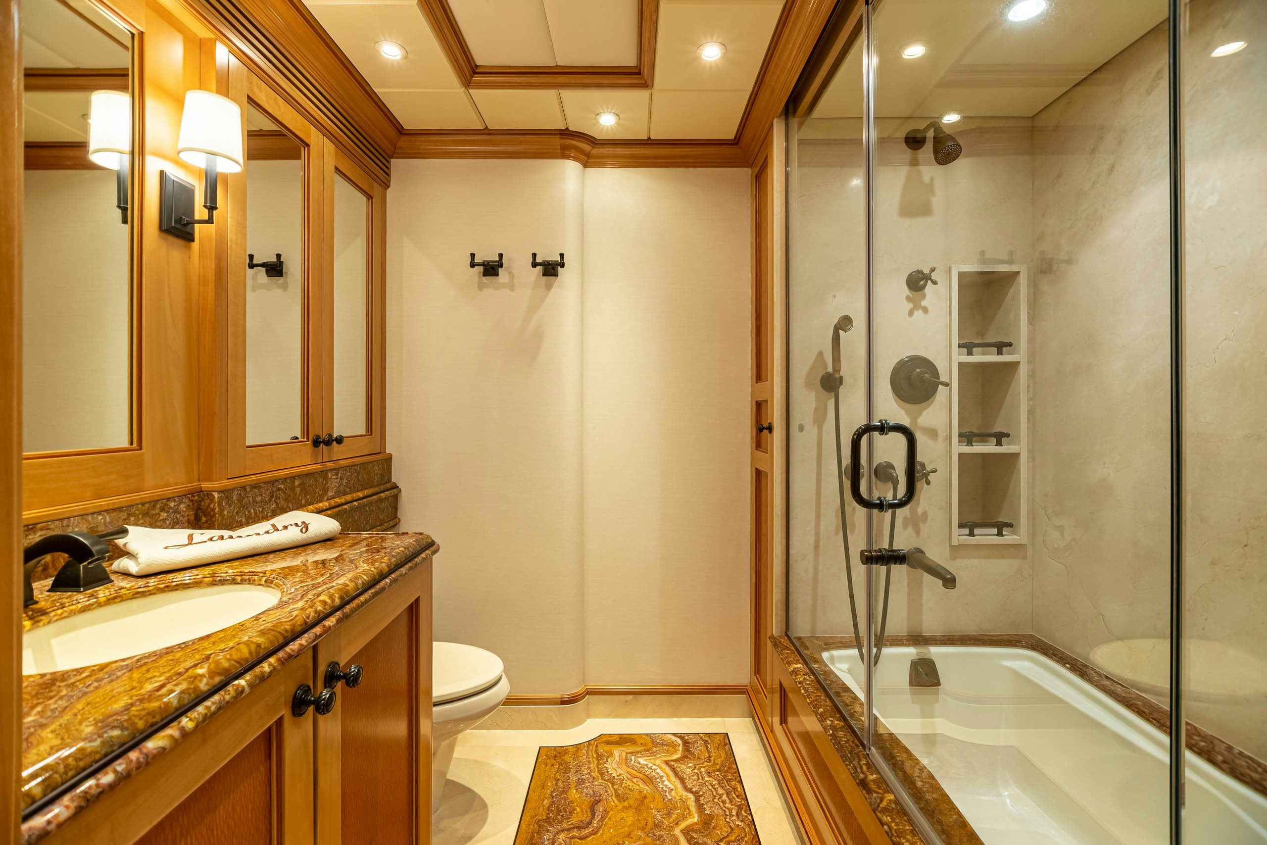 a bathroom with a glass shower aboard UNBRIDLED Yacht for Charter