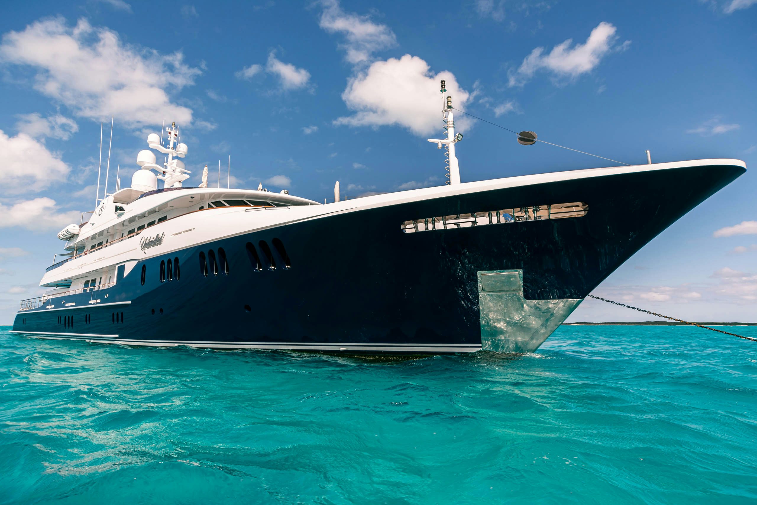 a large white boat in the water aboard UNBRIDLED Yacht for Charter
