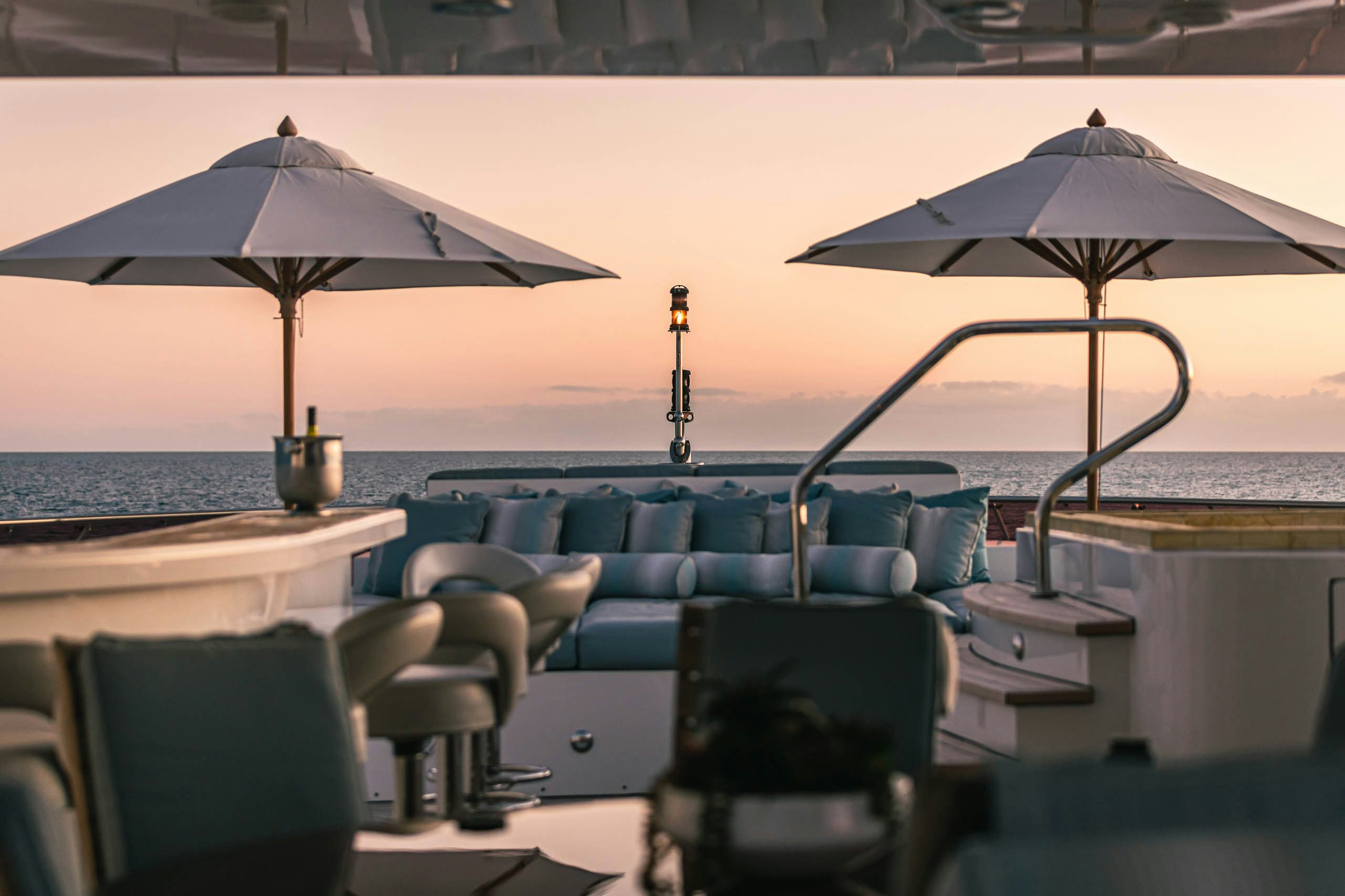 a group of umbrellas on a patio by a beach aboard UNBRIDLED Yacht for Charter