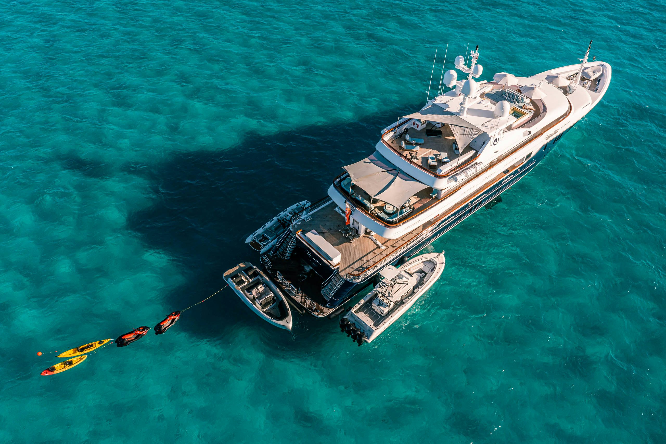 a helicopter flying over a boat aboard UNBRIDLED Yacht for Charter