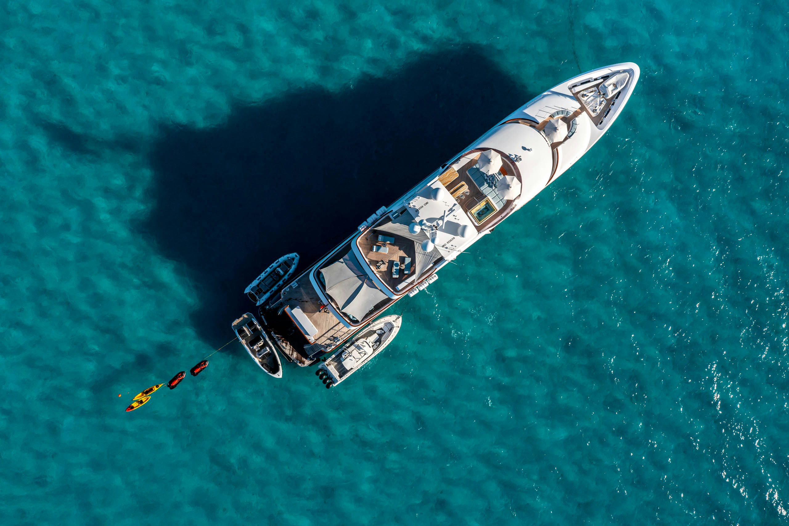a helicopter flying over a forest aboard UNBRIDLED Yacht for Charter