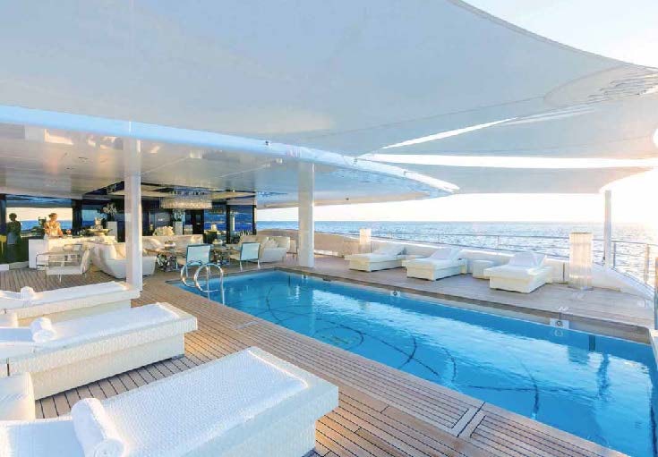 a large modern building with a swimming pool aboard LADY LARA Yacht for Sale