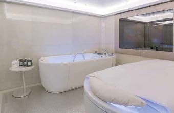 a large white bathtub in a bathroom aboard LADY LARA Yacht for Sale