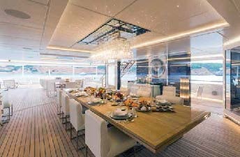 a large room with a table and chairs aboard LADY LARA Yacht for Sale