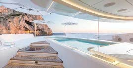 a pool with a staircase and a large building in the background aboard LADY LARA Yacht for Sale