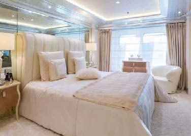 a bed with white sheets aboard LADY LARA Yacht for Sale