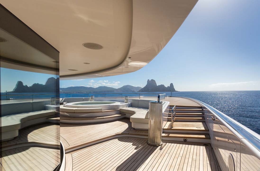 a deck with a view of the ocean and mountains aboard LADY LARA Yacht for Sale