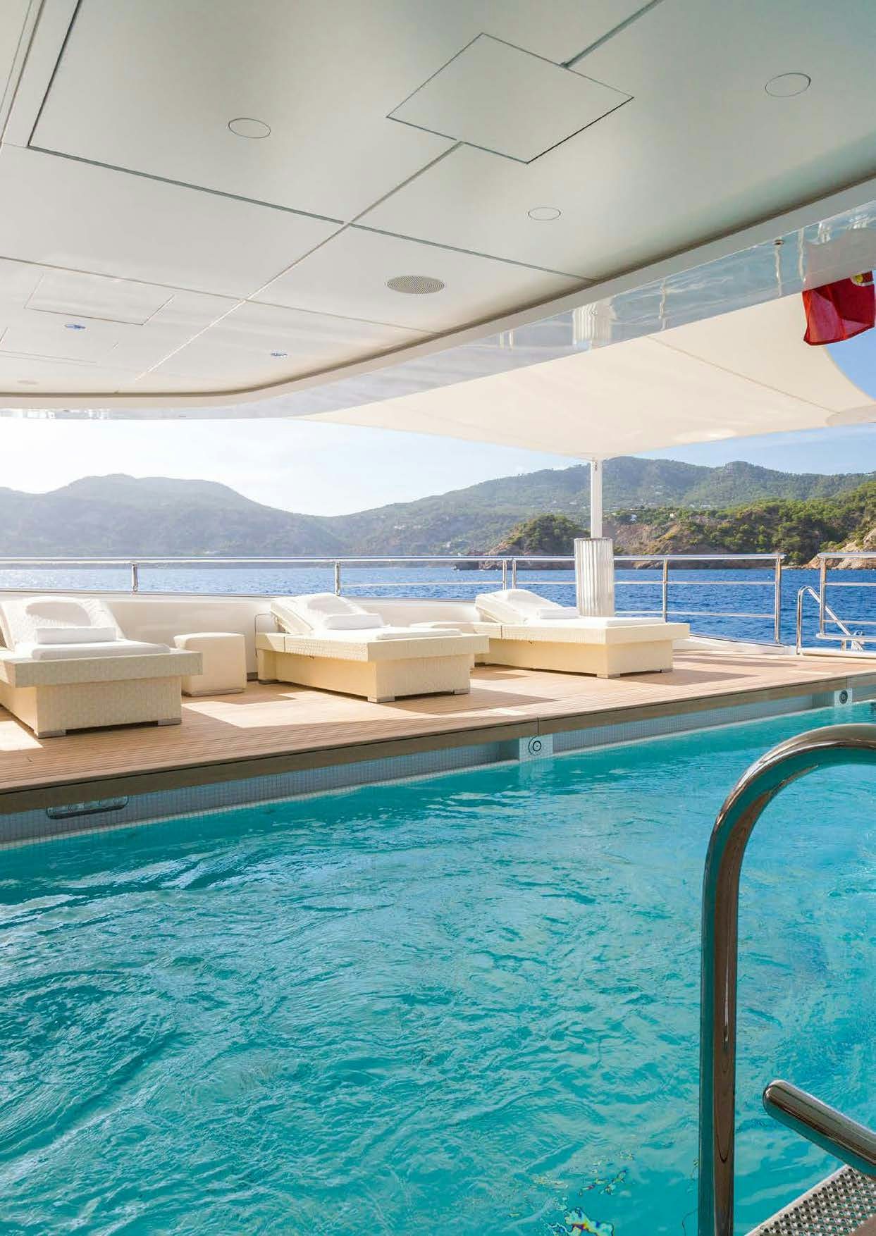 a pool with a view of mountains and water aboard LADY LARA Yacht for Sale
