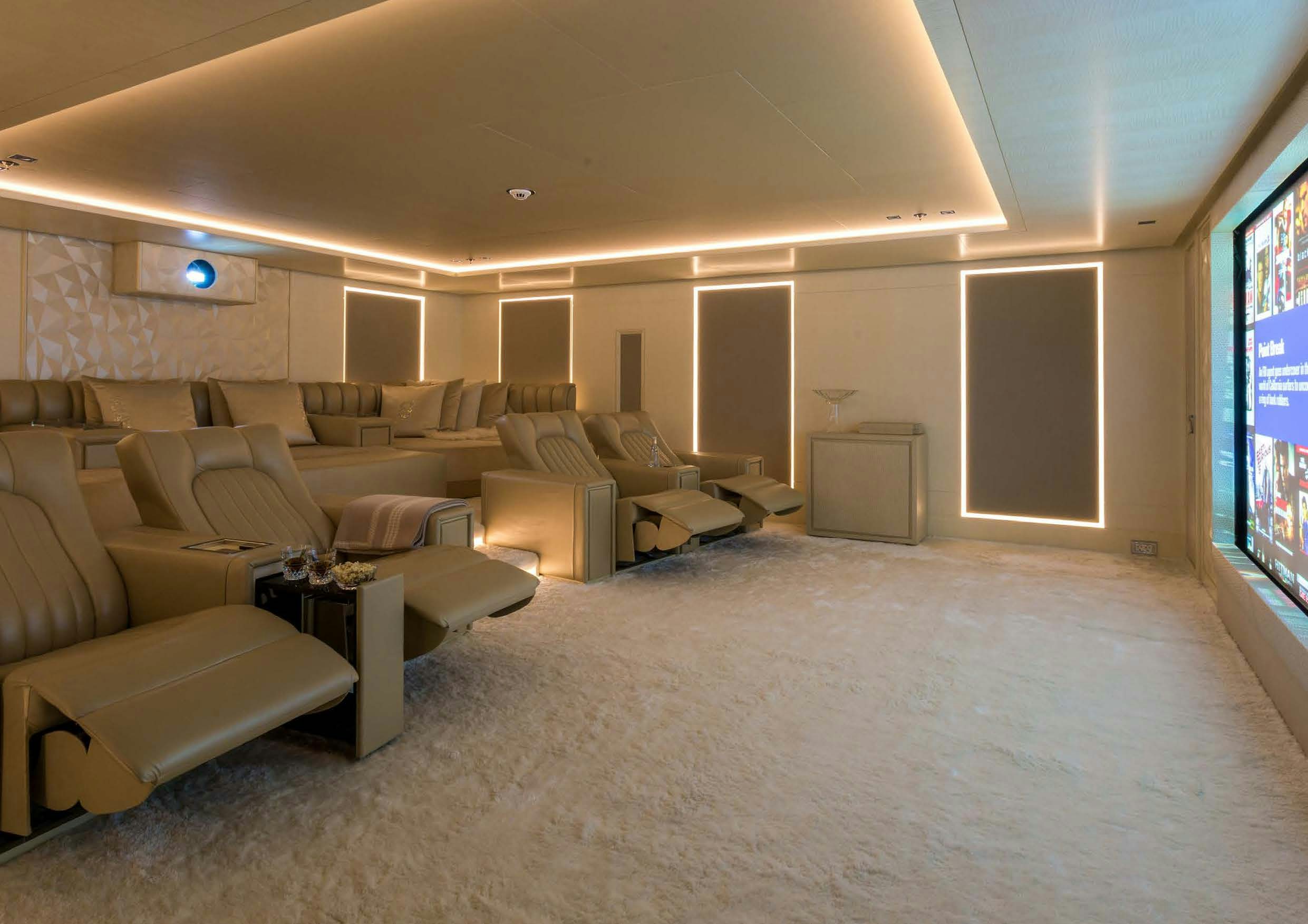 a large living room with a large screen aboard LADY LARA Yacht for Sale