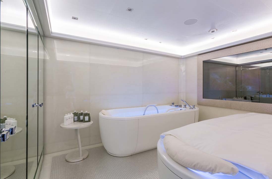 a bathroom with a tub sink and a mirror aboard LADY LARA Yacht for Sale