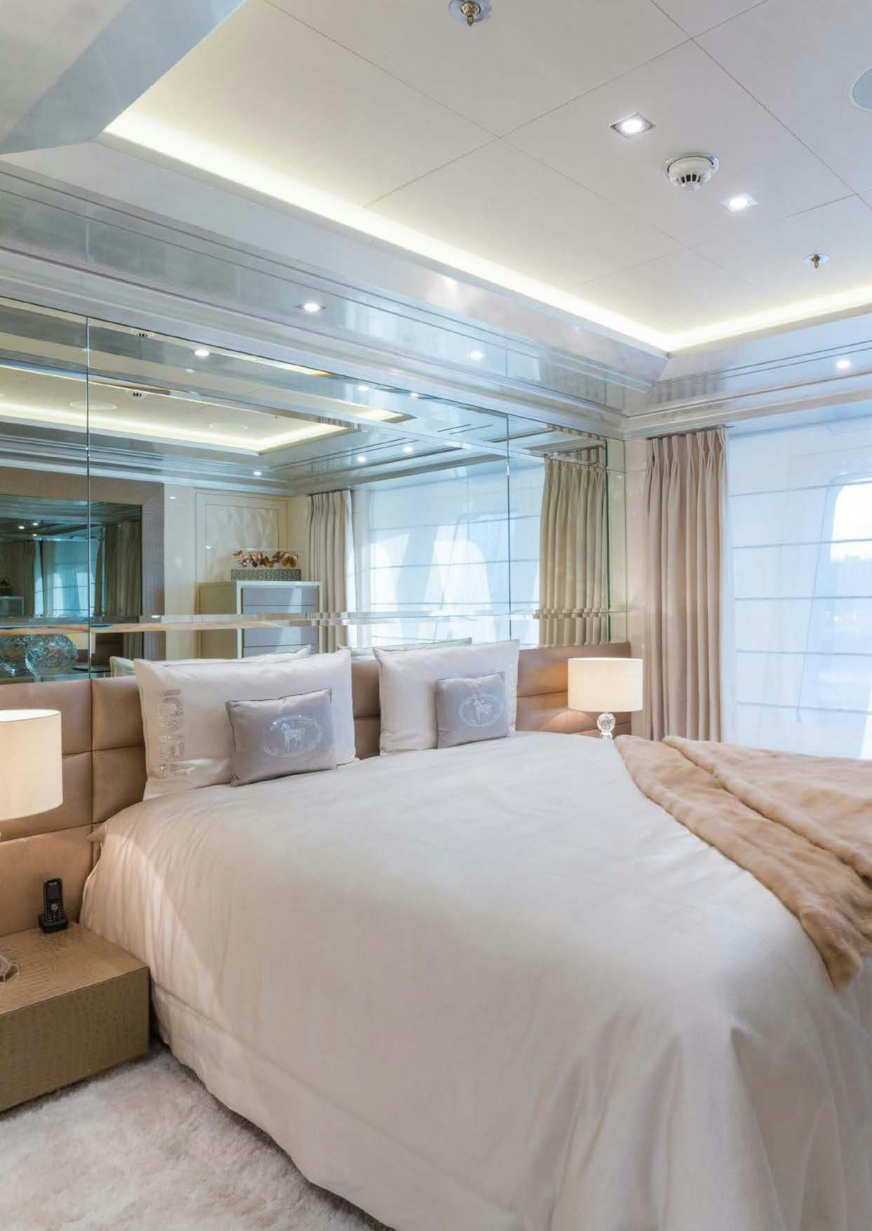 a bed with a white bed spread aboard LADY LARA Yacht for Sale