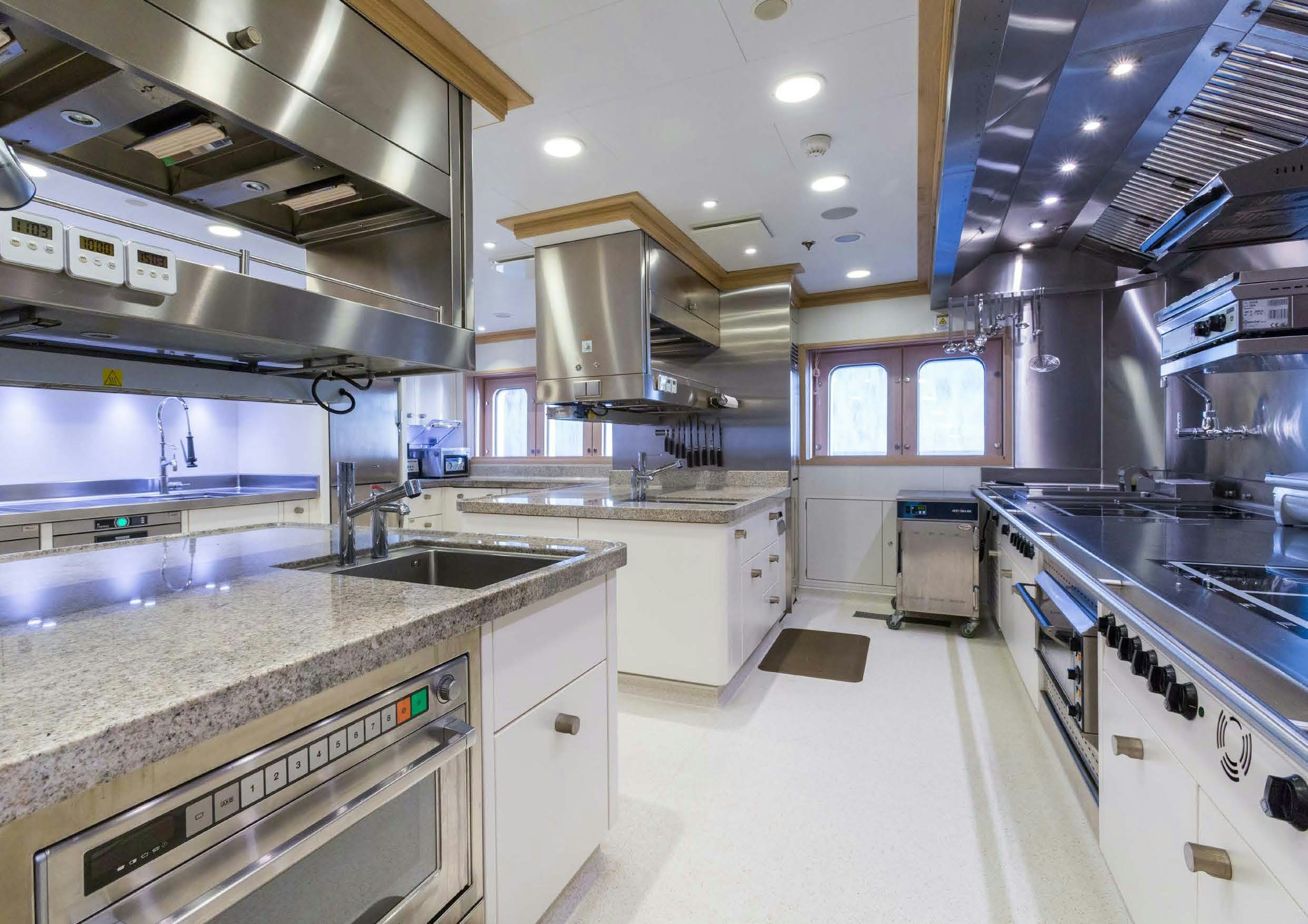 a kitchen with a large island aboard LADY LARA Yacht for Sale