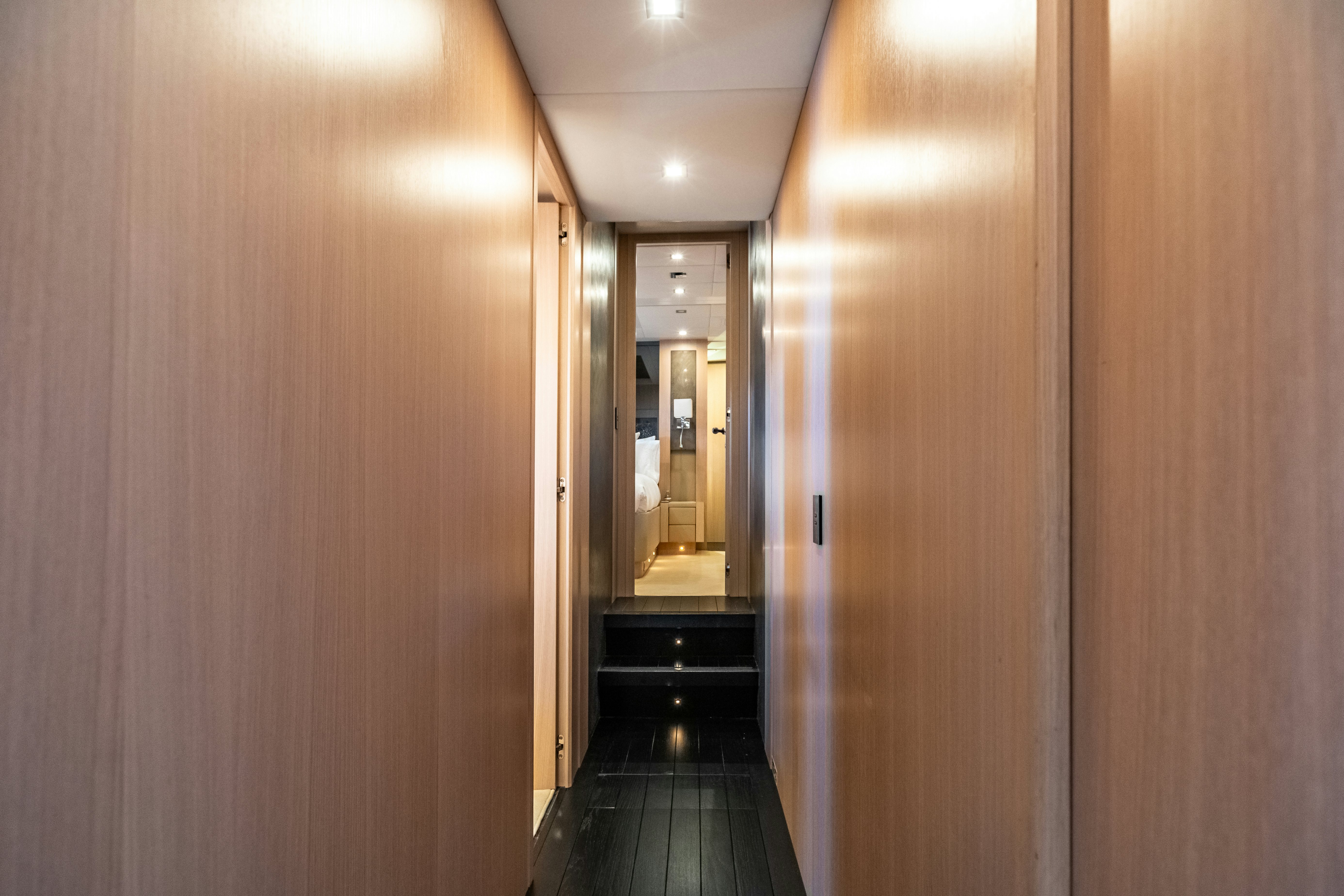 a hallway with wooden doors aboard TOTAL Yacht for Sale