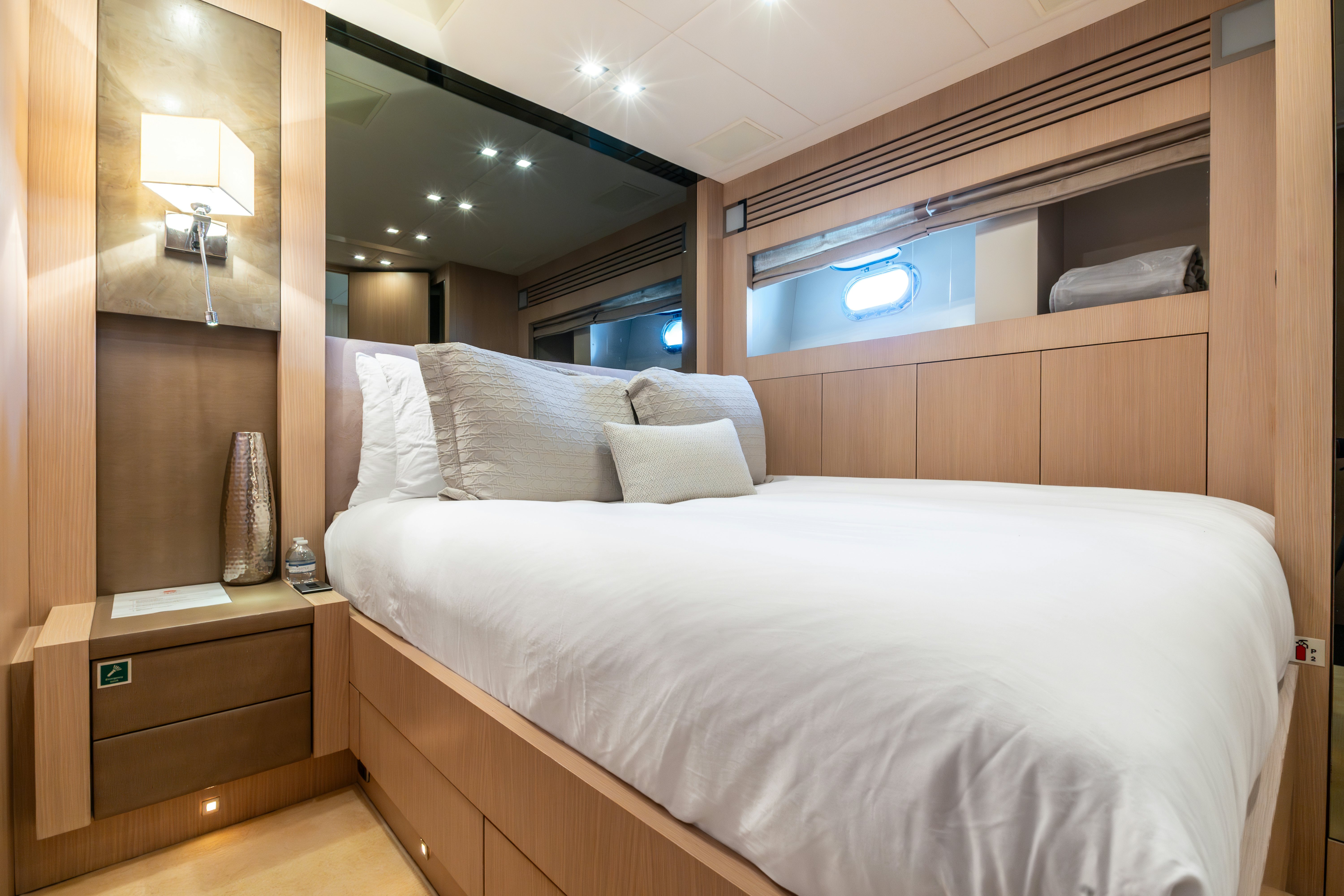 a bed with a white bed spread aboard TOTAL Yacht for Sale