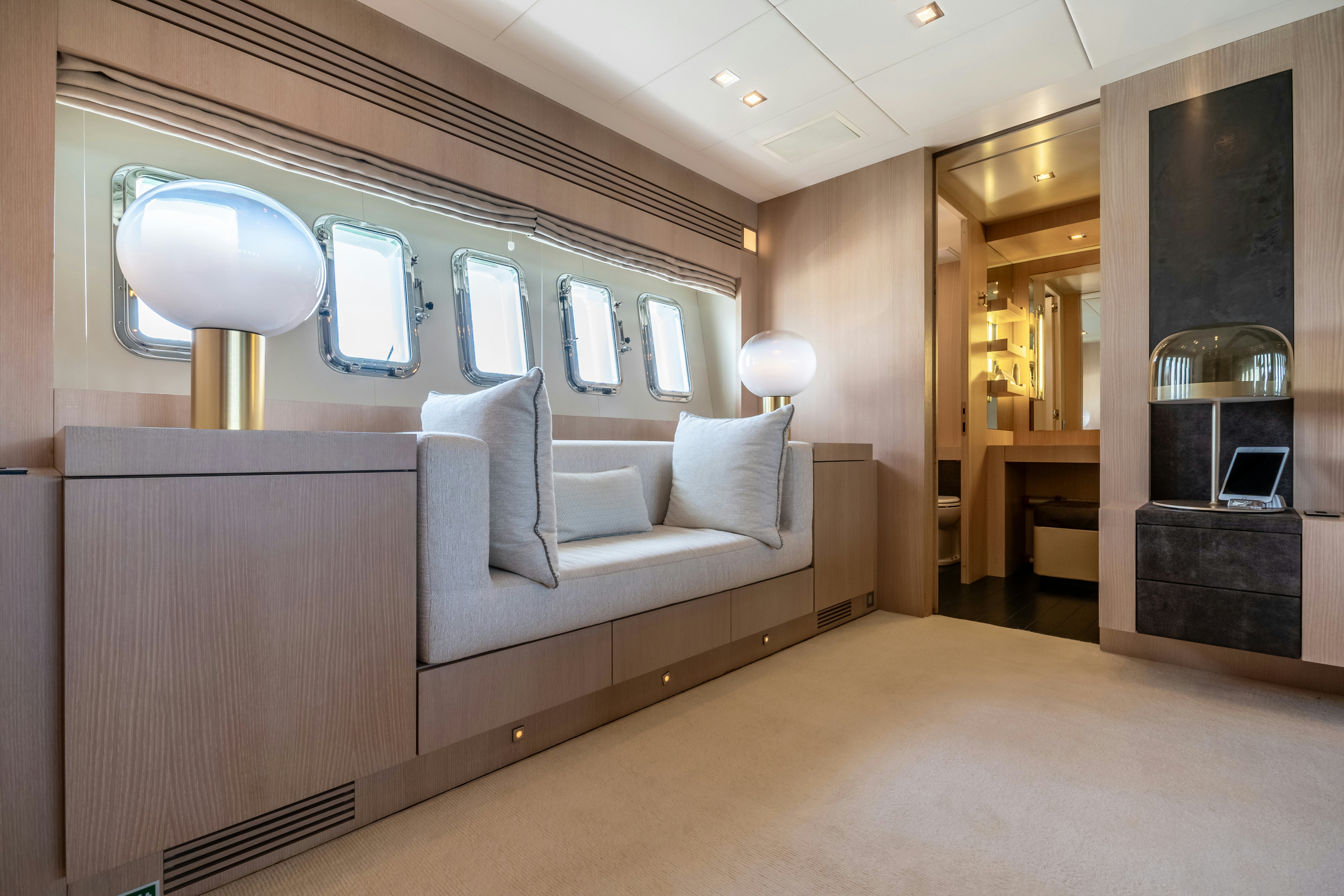 a room with a couch and a fireplace aboard TOTAL Yacht for Sale