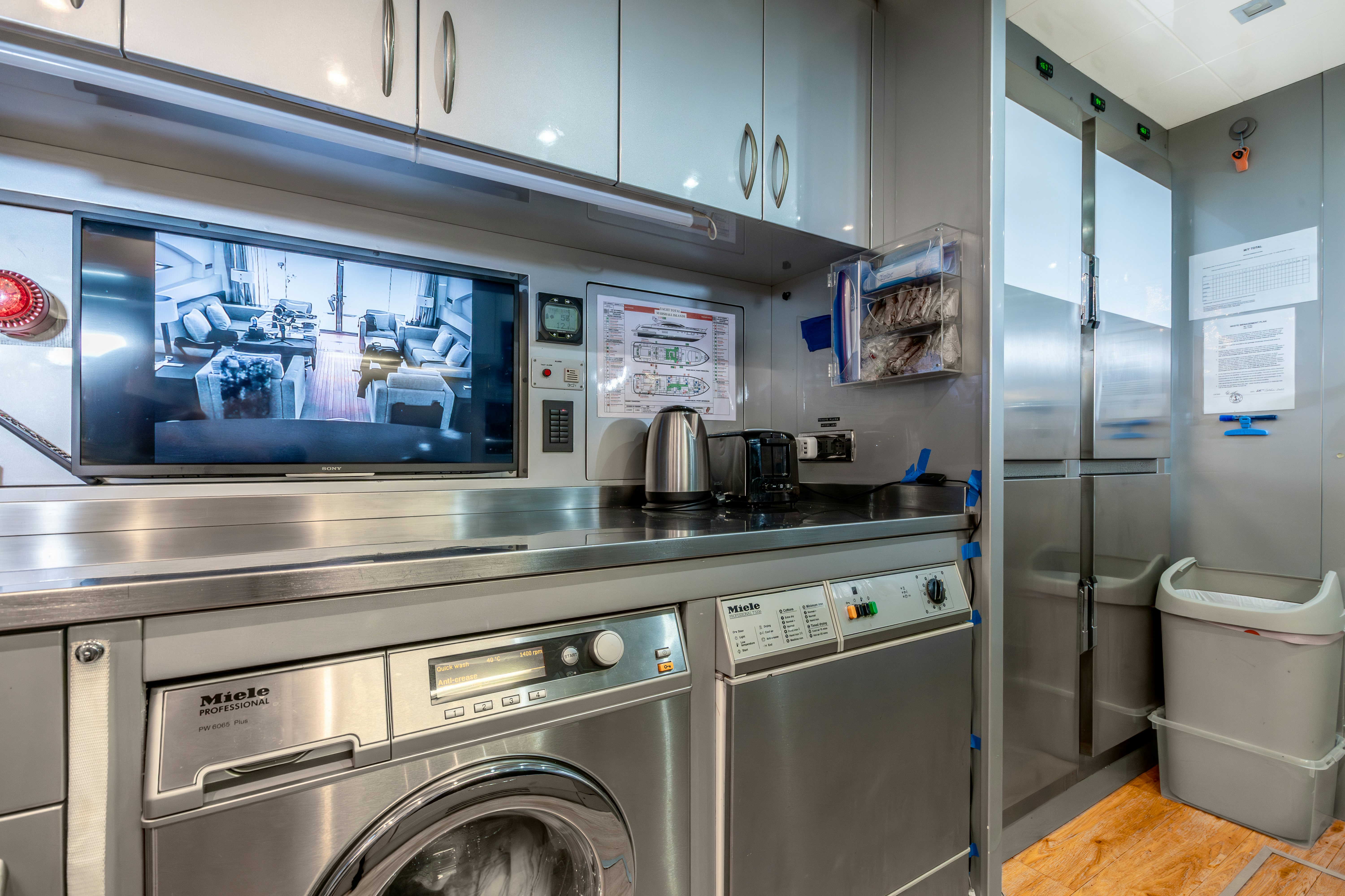 a kitchen with a large stainless steel oven and a large glass door aboard TOTAL Yacht for Sale