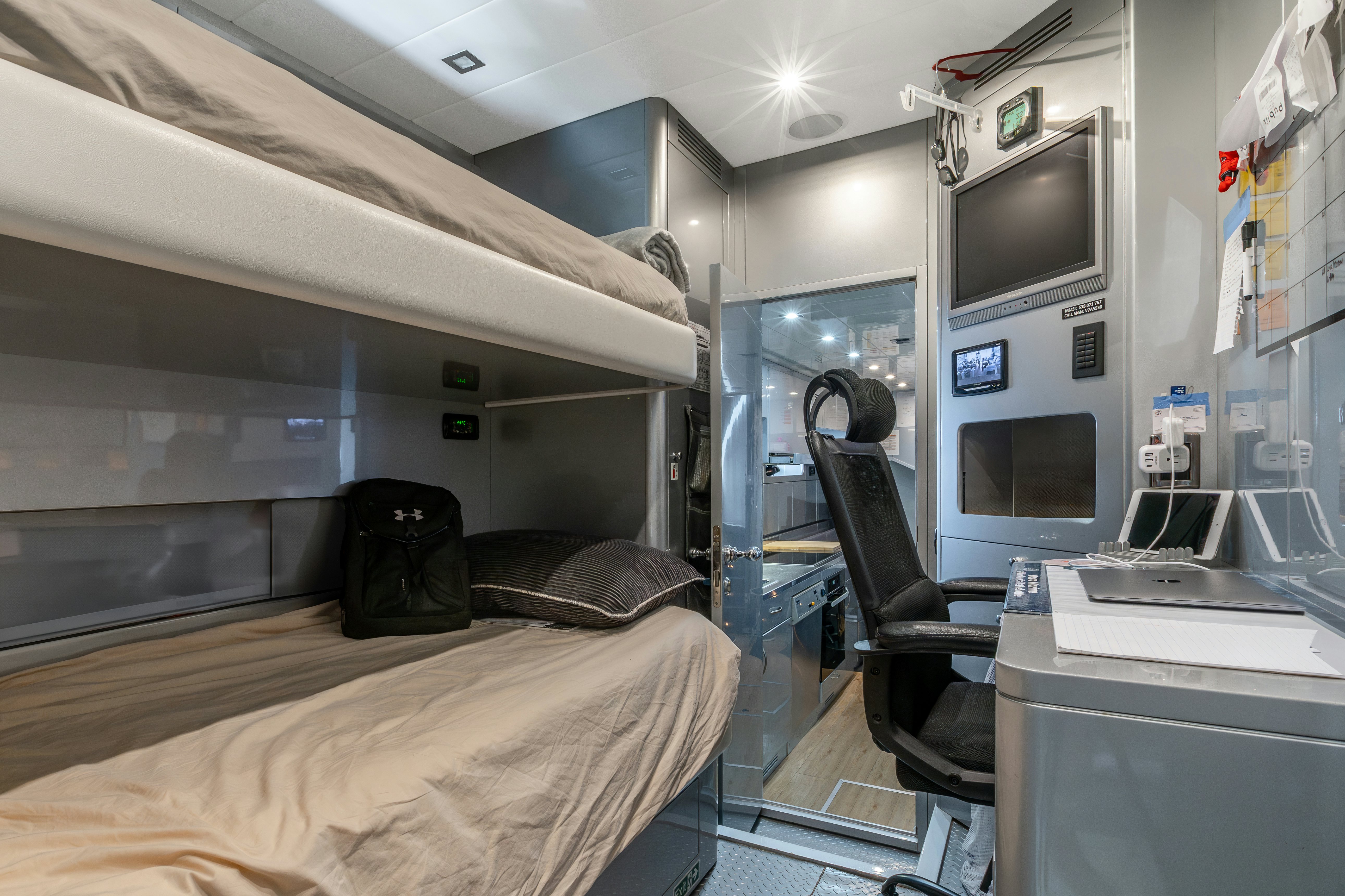 a room with a bed and a desk aboard TOTAL Yacht for Sale