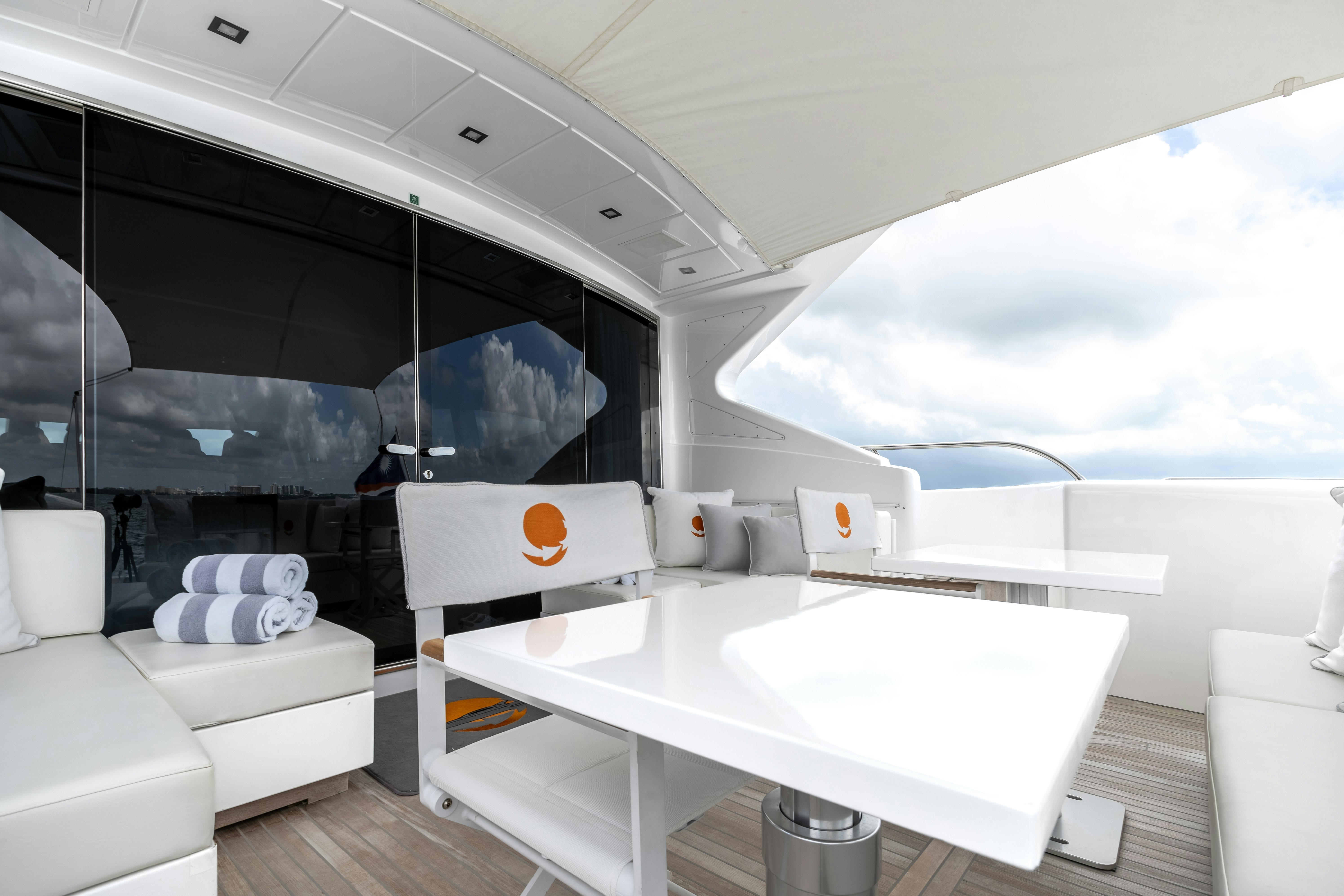 a room with a table and chairs aboard TOTAL Yacht for Sale