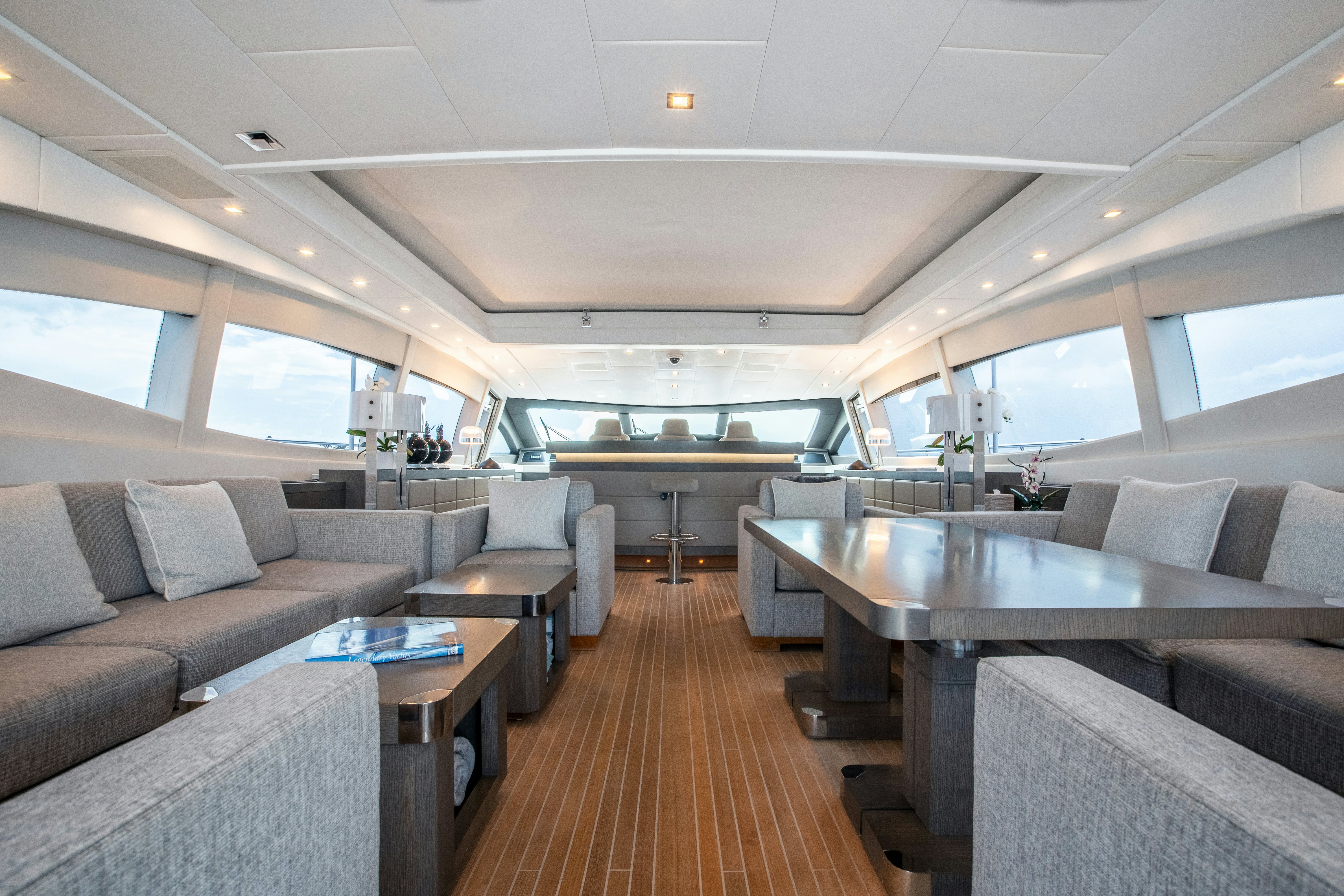 a large living room with a wood floor aboard TOTAL Yacht for Sale
