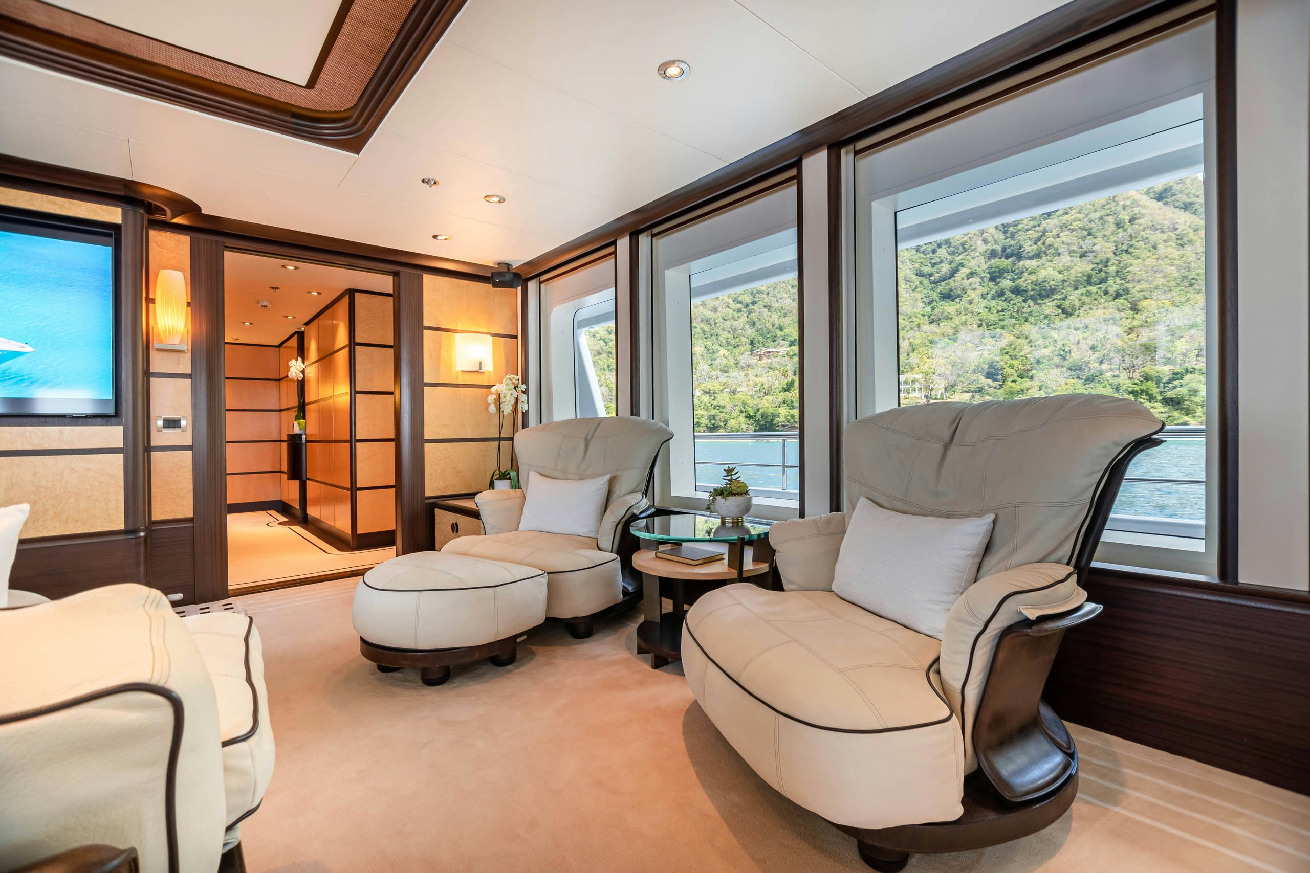 a living room with a large window aboard HARLE Yacht for Charter