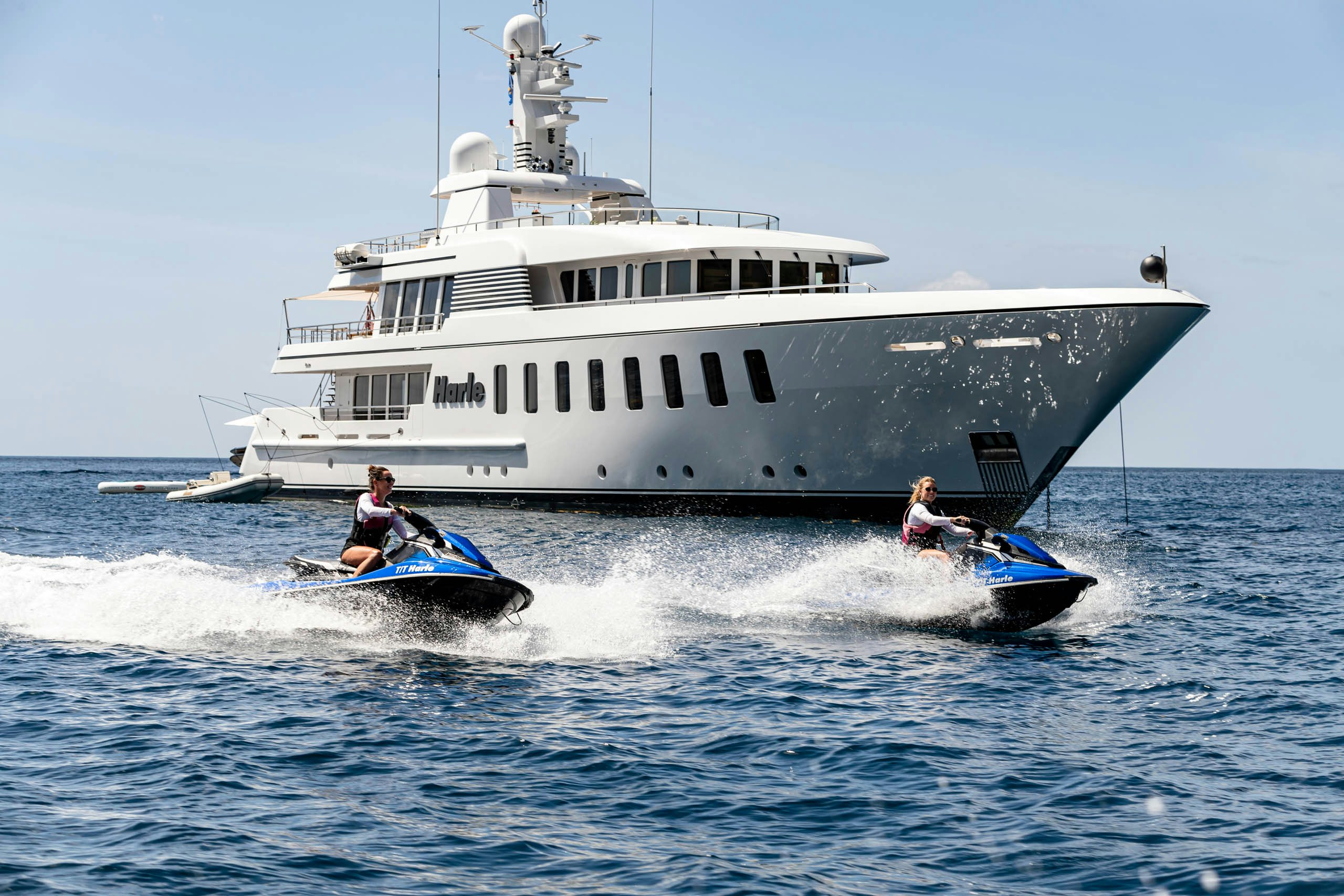 a boat with a couple of people in it aboard HARLE Yacht for Charter