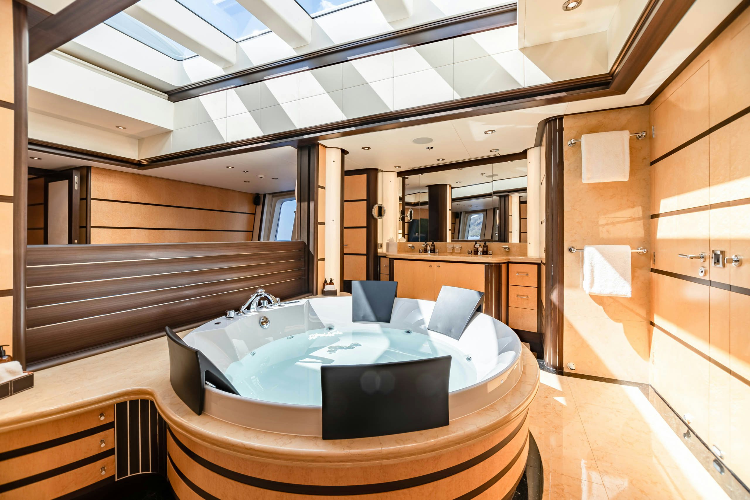 a room with a bed and a large mirror aboard HARLE Yacht for Charter