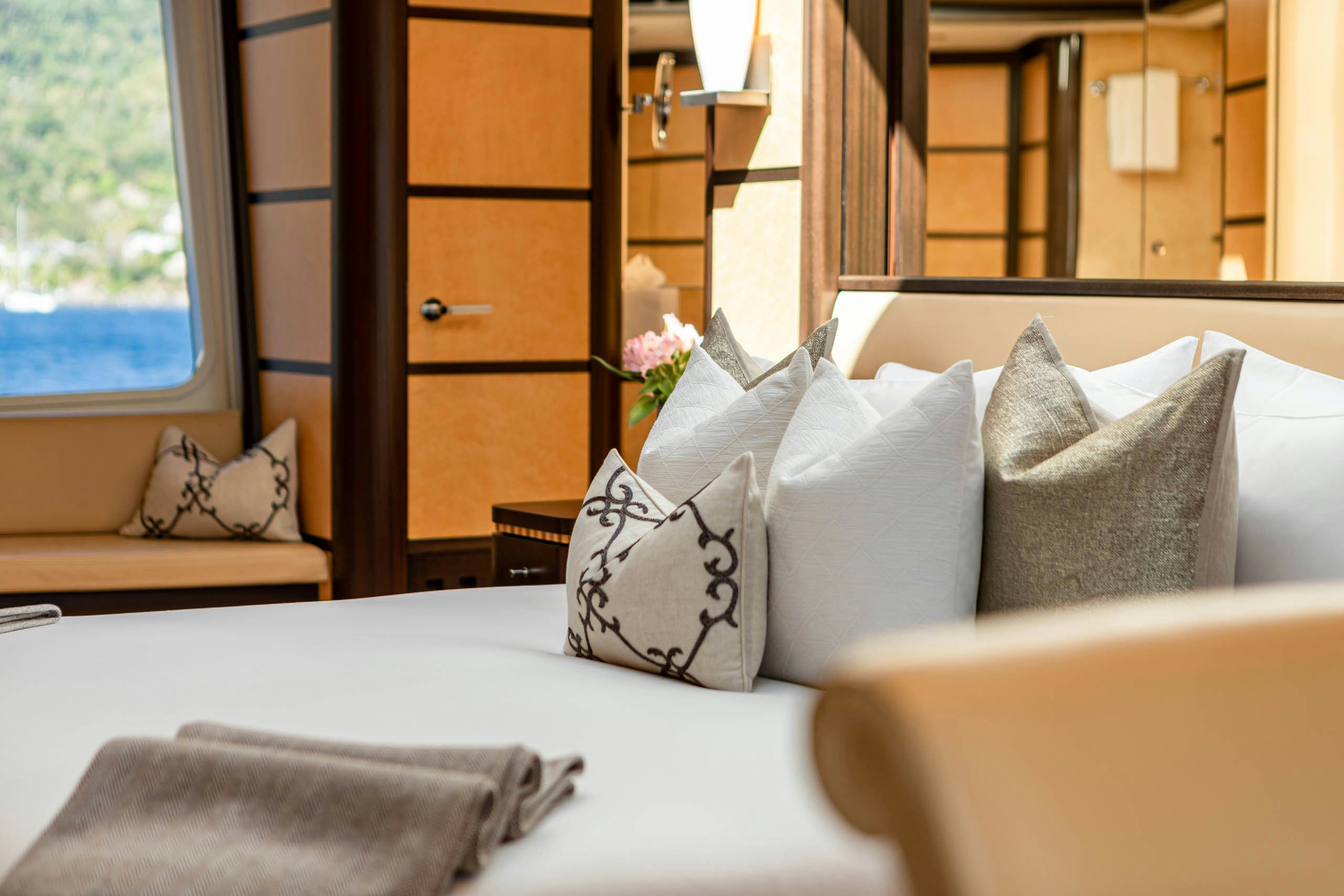 a bed with pillows and pillows aboard HARLE Yacht for Charter